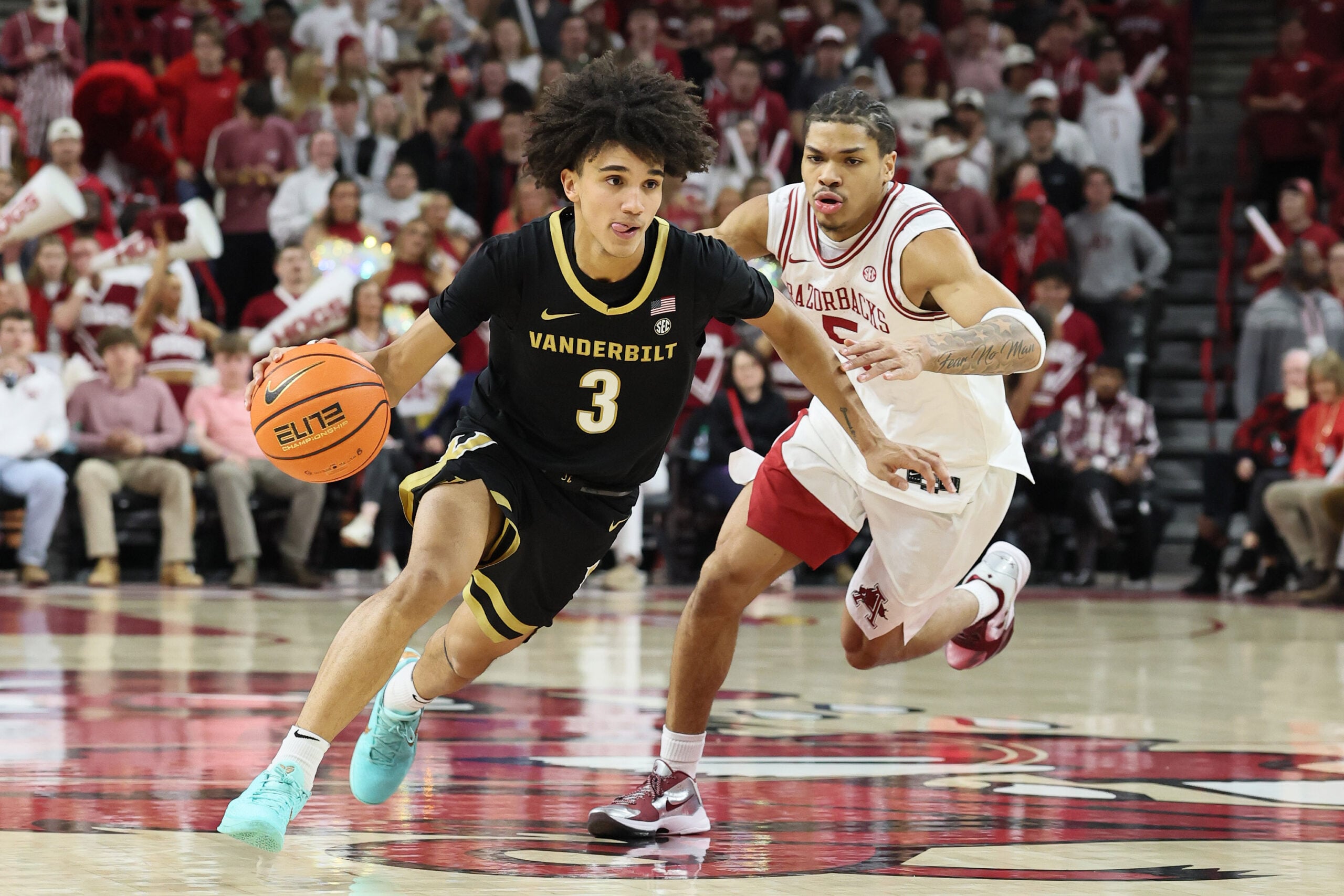 Jan 20, 2026; Fayetteville, Arkansas, USA; Vanderbilt Commodores guard Tyler Tanner (3) drives against Arkansas Razorbacks guard Darius Acuff Jr (5) during the second half at Bud Walton Arena. Arkansas won 93-68. Mandatory Credit: Nelson Chenault-Imagn Images
