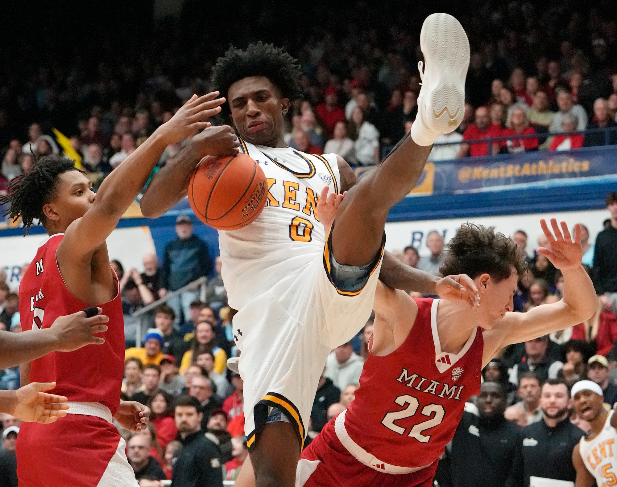 Kent State’s Rayvon Griffith pulls down a rebound as Miami’s Eian Elmer and Brant Byers defend during the game at the MAC Center in Kent on Jan. 20, 2026.