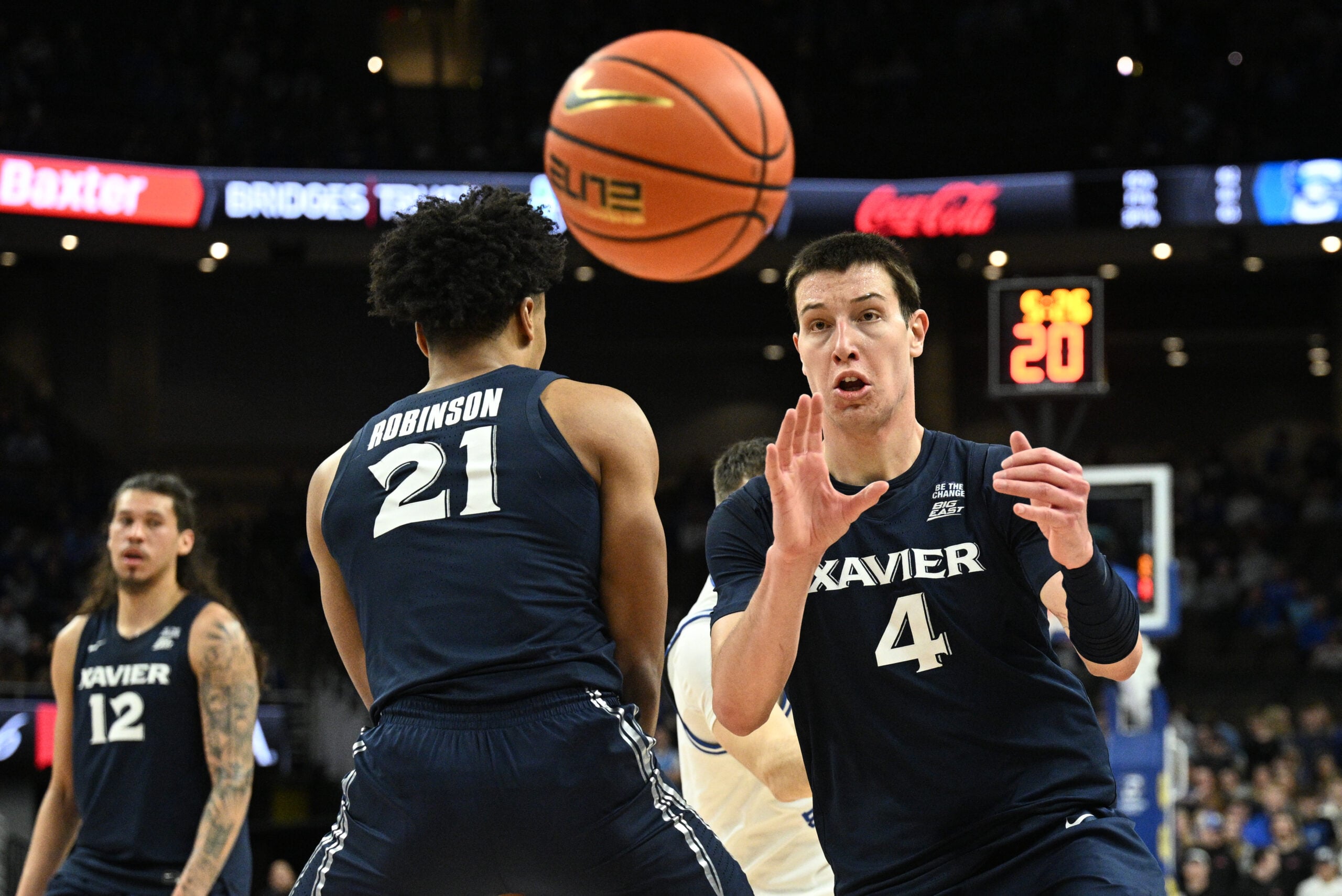 Jan 21, 2026; Omaha, Nebraska, USA;  Xavier Musketeers forward Filip Borovicanin (4) receives an inbound pass against the Creighton Bluejays during the first half at CHI Health Center Omaha. Mandatory Credit: Steven Branscombe-Imagn Images
