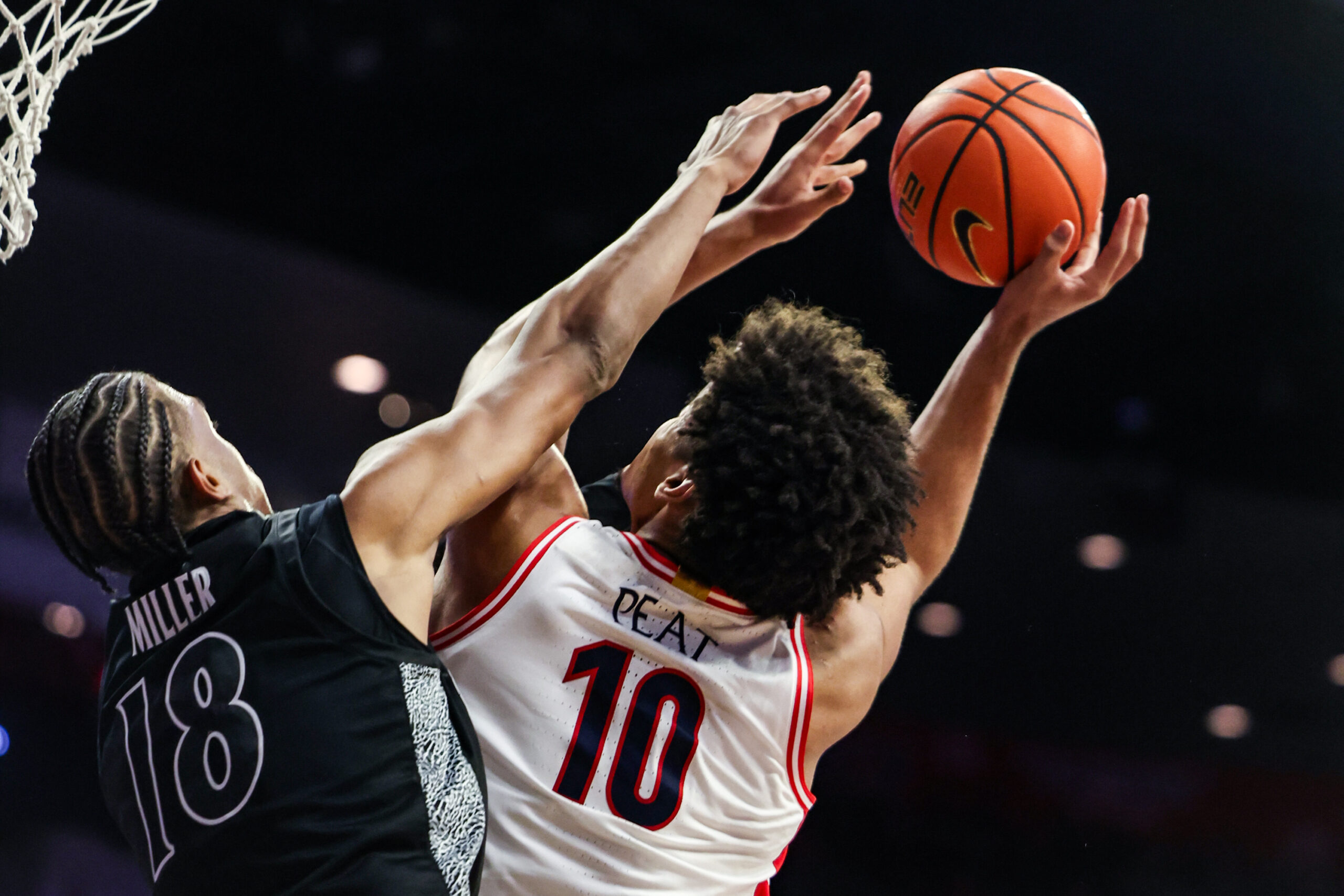 Jan 21, 2026; Tucson, Arizona, USA; Cincinnati Bearcats forward Baba Miller (18) fouls Arizona Wildcats forward Koa Peat (10) during the second half of the game at McKale Memorial Center. Mandatory Credit: Aryanna Frank-Imagn Images
