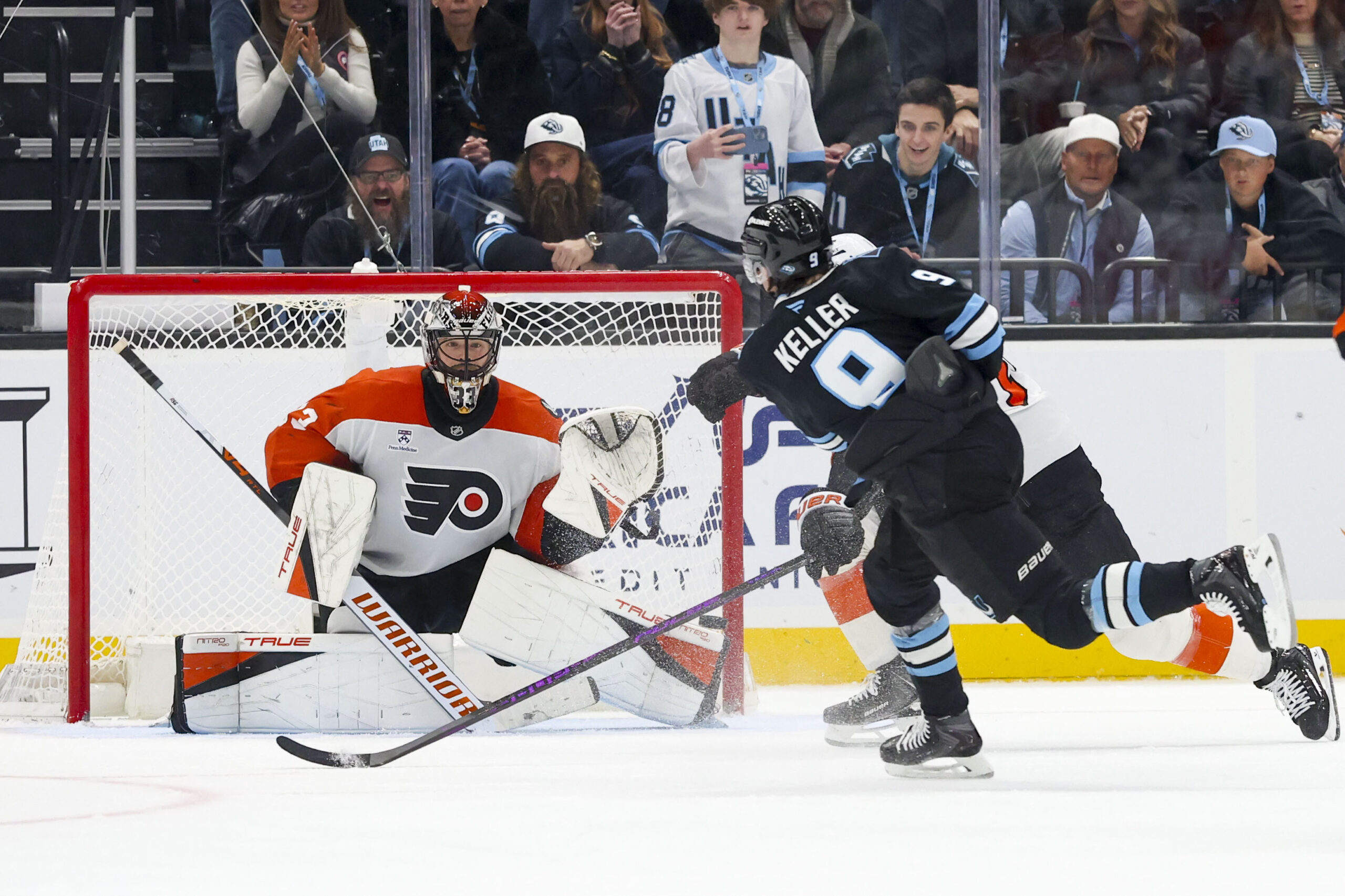 Jan 21, 2026; Salt Lake City, Utah, USA; Utah Mammoth right wing Clayton Keller (9) scores a goal against Philadelphia Flyers goaltender Samuel Ersson (33) to win the game in overtime at Delta Center. Mandatory Credit: Rob Gray-Imagn Images