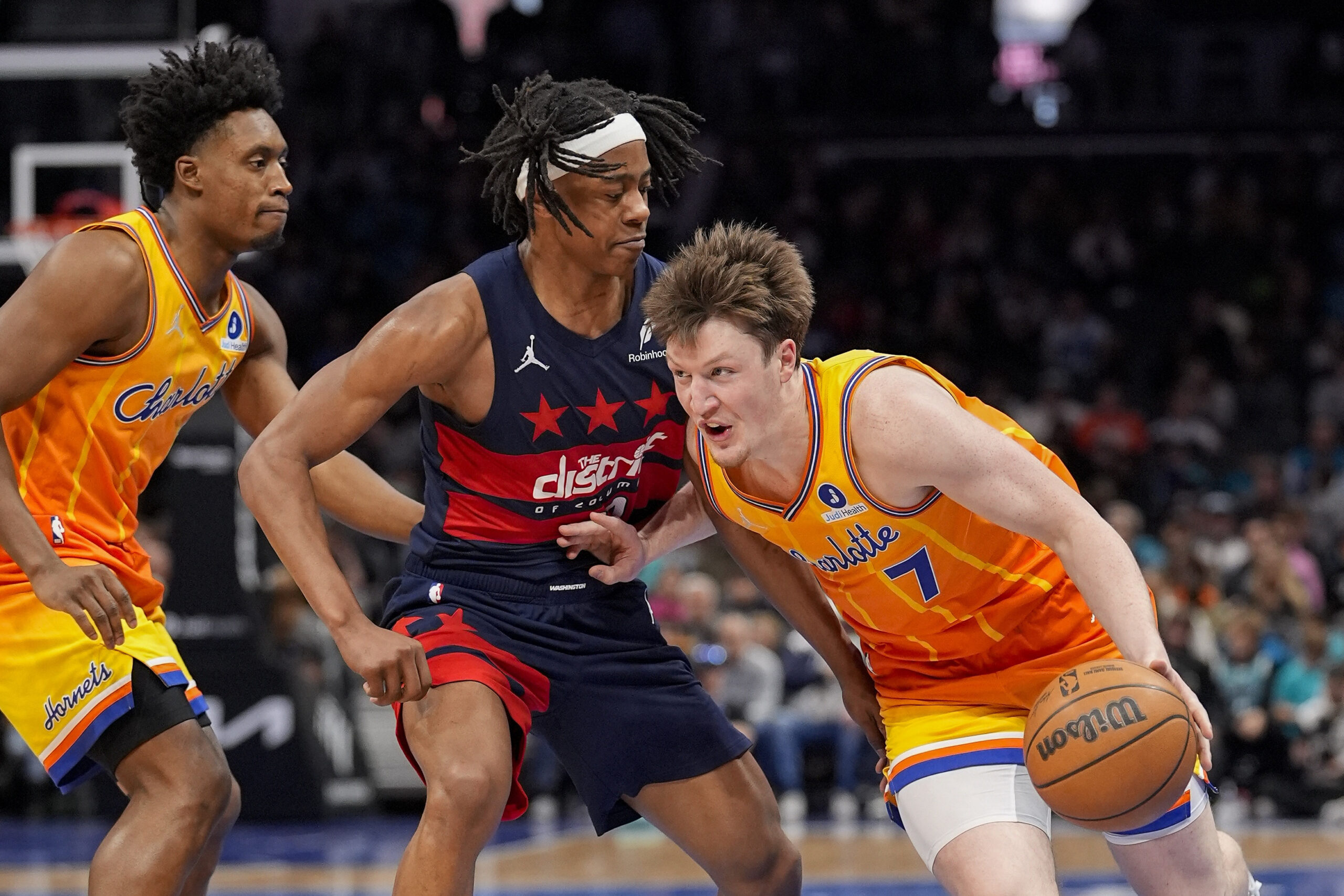 Jan 24, 2026; Charlotte, North Carolina, USA; Charlotte Hornets guard/forward Kon Knueppel (7) drives to the basket against Washington Wizards guard Tre Johnson (12) during the second half at the Spectrum Center. Mandatory Credit: Jim Dedmon-Imagn Images