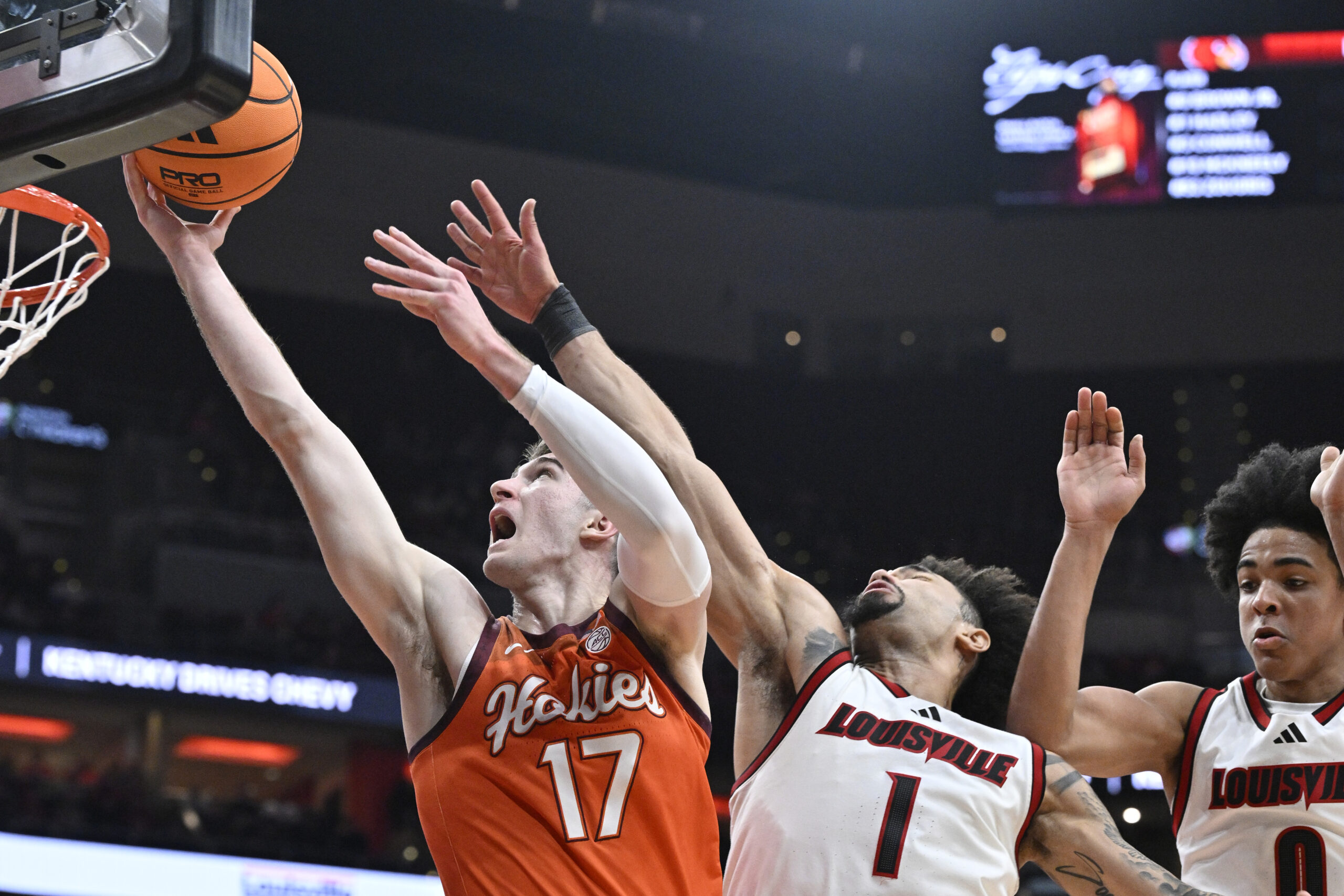 Jan 24, 2026; Louisville, Kentucky, USA;  Virginia Tech Hokies guard Neoklis Avdalas (17) shoots against Louisville Cardinals guard J'vonne Hadley (1) and guard Mikel Brown Jr. (0) during the first half at KFC Yum! Center. Mandatory Credit: Jamie Rhodes-Imagn Images