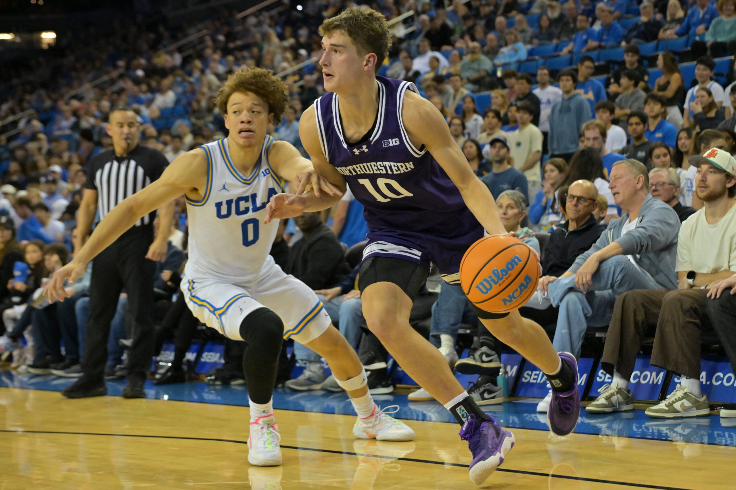 Jan 24, 2026; Los Angeles, California, USA;  Northwestern Wildcats guard Max Green (10) is defended by UCLA Bruins guard Trent Perry (0) as he drives to the basket in the second half at Pauley Pavilion presented by Wescom Financial. Mandatory Credit: Jayne Kamin-Oncea-Imagn Images