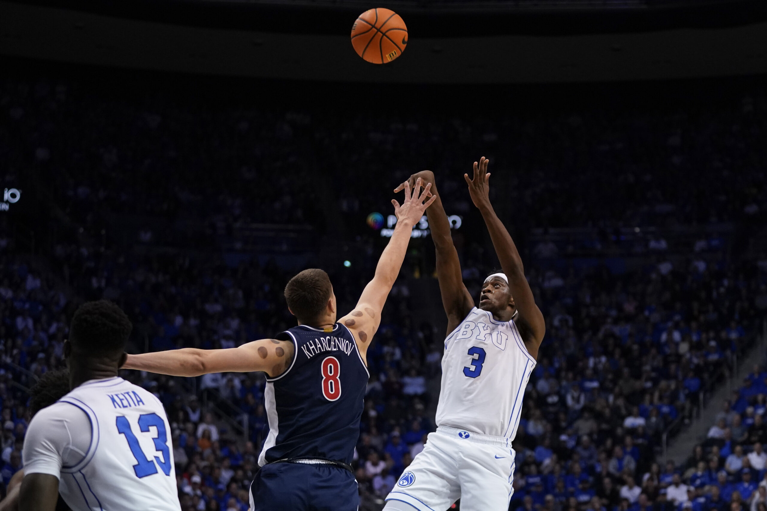 Jan 26, 2026; Provo, Utah, USA; BYU Cougars forward AJ Dybantsa (3) shoots the ball while being defended by Arizona Wildcats forward Ivan Kharchenkov (8) during the first half at Marriott Center. Mandatory Credit: Aaron Baker-Imagn Images