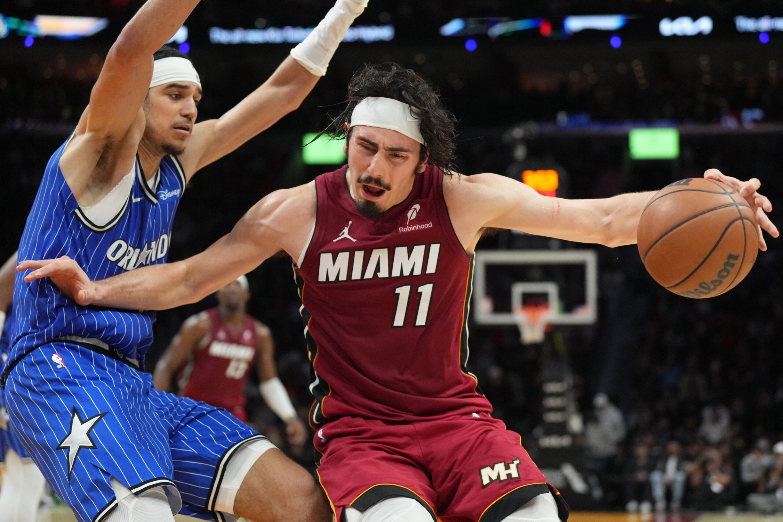 Jan 28, 2026; Miami, Florida, USA; Miami Heat forward Jaime Jaquez Jr. (11) tries to drive past Orlando Magic guard Anthony Black (0) during the second half at Kaseya Center. Mandatory Credit: Jim Rassol-Imagn Images