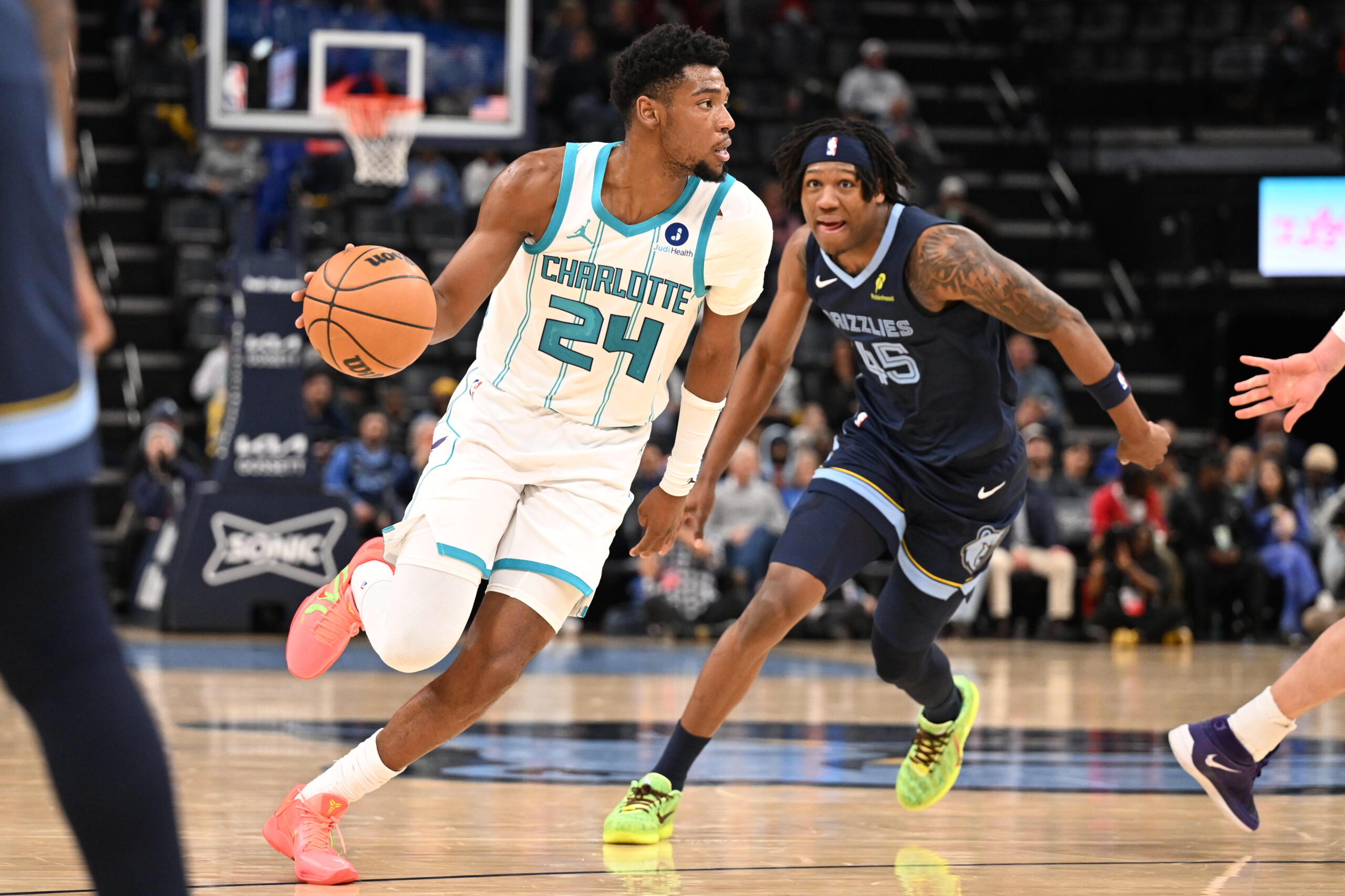 Jan 28, 2026; Memphis, Tennessee, USA; Charlotte Hornets forward Brandon Miller (24) drives past defender Memphis Grizzlies forward GG Jackson (45) in the third quarter at FedExForum. Mandatory Credit: Matthew Smith-Imagn Images