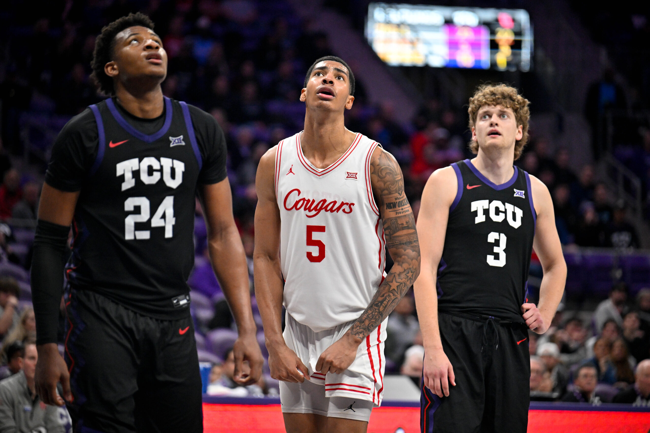 Jan 28, 2026; Fort Worth, Texas, USA; TCU Horned Frogs forward Xavier Edmonds (24) and guard Liutauras Lelevicius (3) and Houston Cougars forward Chris Cenac Jr. (5) look on during the game at Ed and Rae Schollmaier Arena. Mandatory Credit: Jerome Miron-Imagn Images