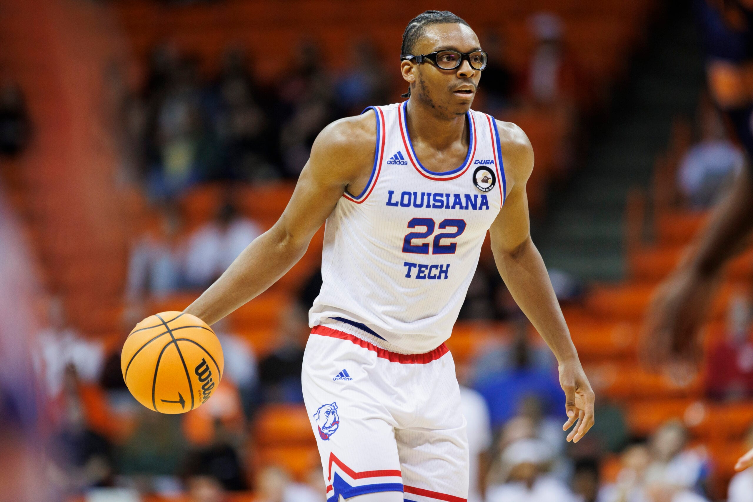 Feb 22, 2024; El Paso, Texas, USA; LA Tech Bulldogs Aggies forward Isaiah Crawford (22) dribbles the ball against the UTEP Miners defense in the first half at Don Haskins Center. Mandatory Credit: Ivan Pierre Aguirre-Imagn Images
