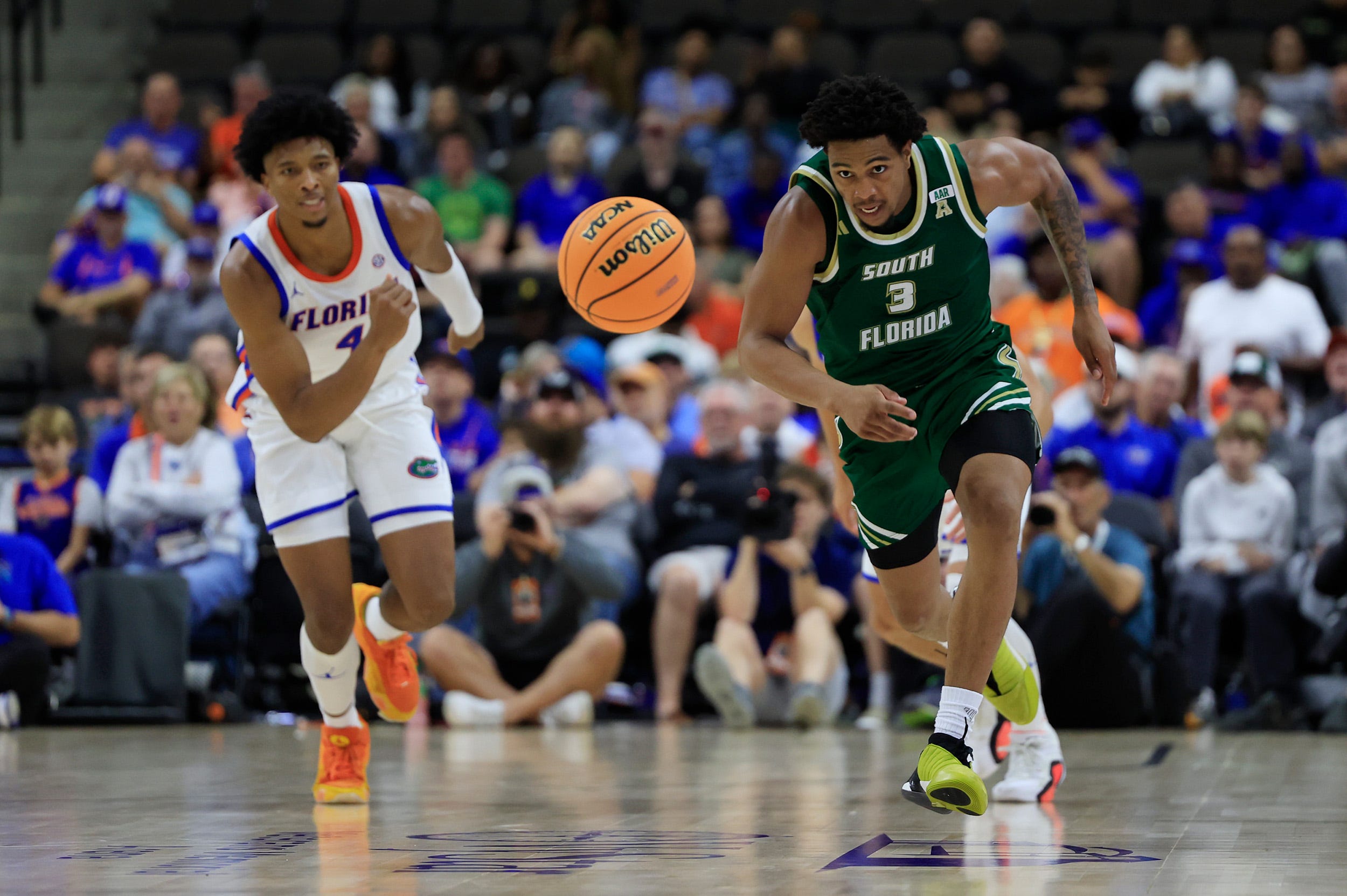 South Florida Bulls guard Jimmie Williams (3) tracks down the balll against Florida Gators forward Sam Alexis (4) during the second half of an NCAA men’s basketball matchup Monday, Nov. 4, 2024 at VyStar Veterans Memorial Arena in Jacksonville, Fla. Florida defeated South Florida 98-83. [Corey Perrine/Florida Times-Union]