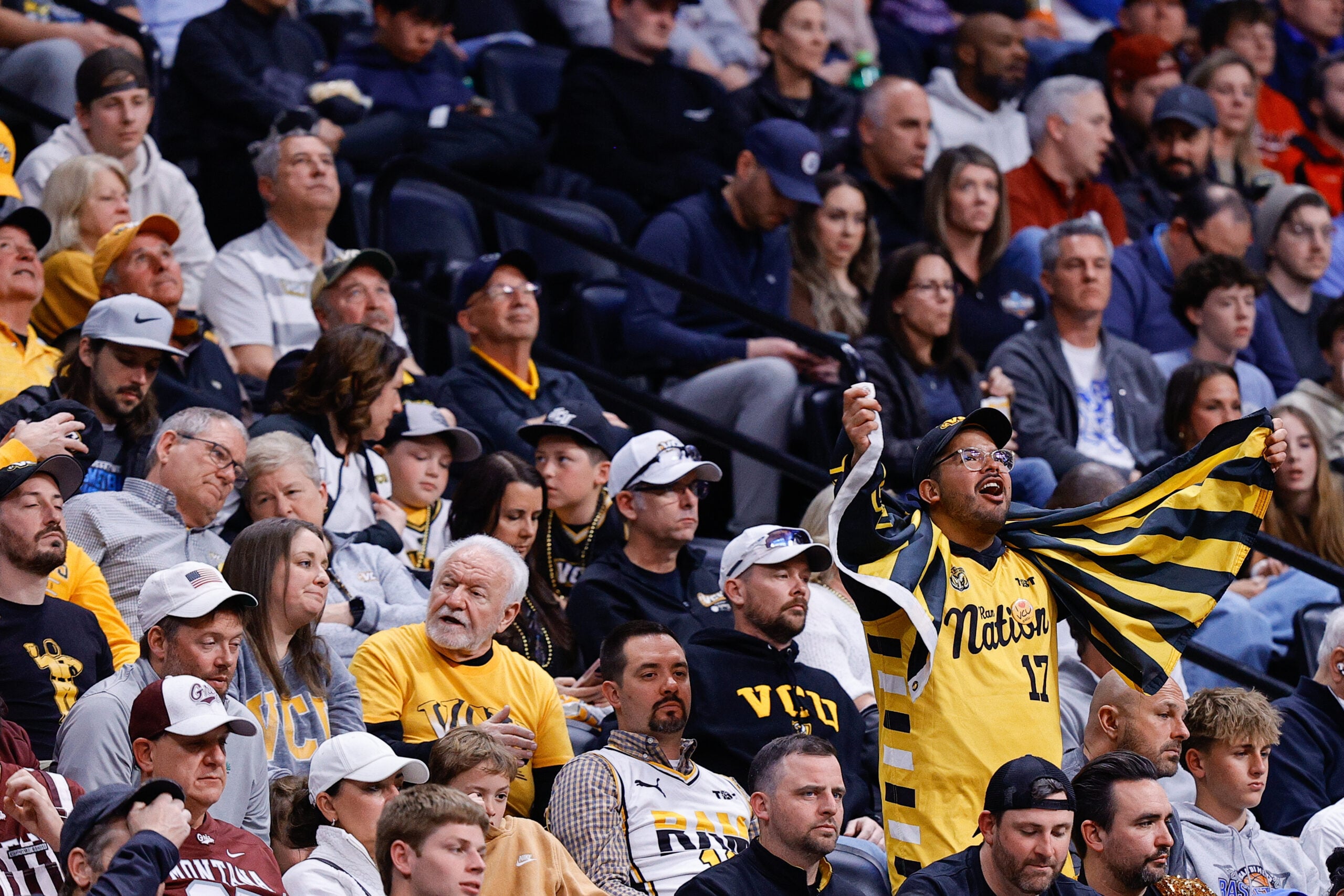 Mar 20, 2025; Denver, CO, USA; A fan for VCU Rams cheers during the second half against the Brigham Young Cougars in the first round of the NCAA Tournament at Ball Arena. Mandatory Credit: Isaiah J. Downing-Imagn Images