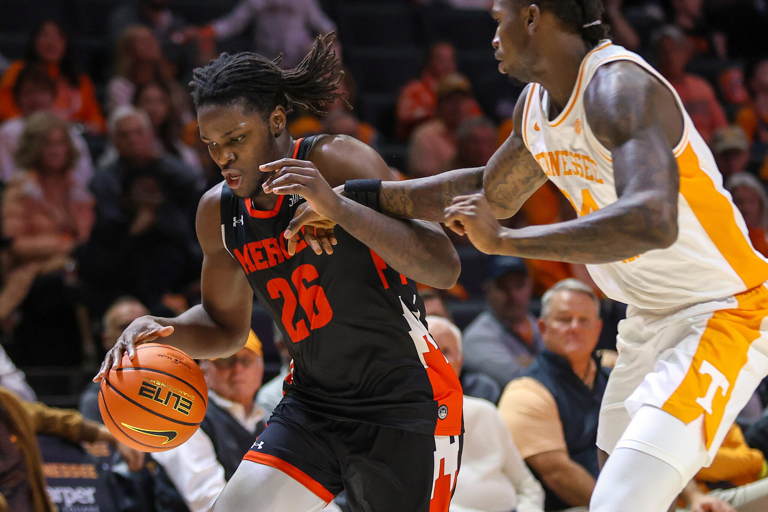 Nov 3, 2025; Knoxville, Tennessee, USA;  Mercer Bears center Armani Mighty (26) moves the ball against Tennessee Volunteers center Felix Okpara (34) during the second half at Thompson-Boling Arena at Food City Center. Mandatory Credit: Randy Sartin-Imagn Images