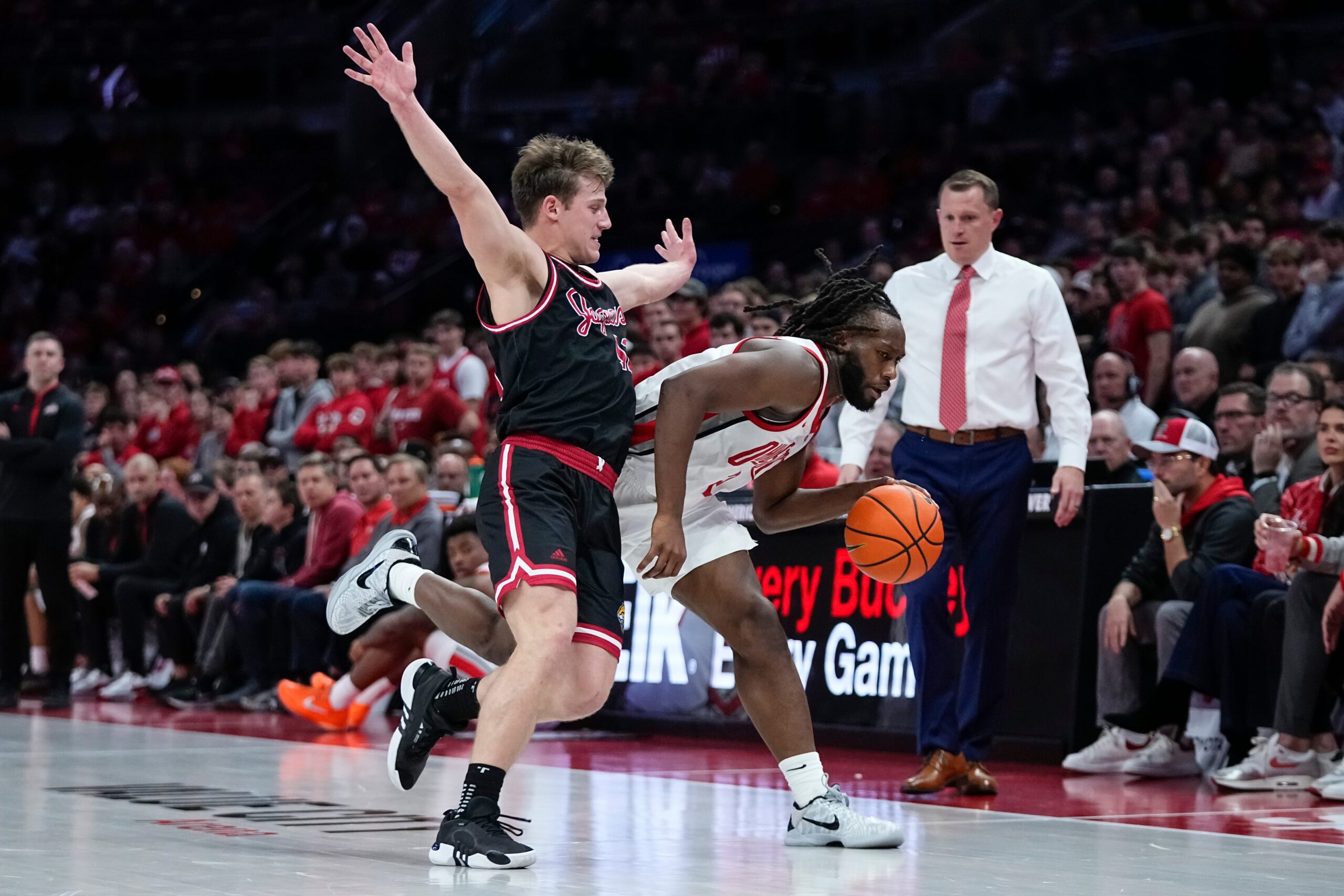 Ohio State Buckeyes guard Bruce Thornton (2) dribbles by IU Indy Jaguars guard Kyler D'Augustino (12) during the NCAA men's basketball game at Value City Arena in Columbus on Nov. 3, 2025. Ohio State won the season opener 118-102.