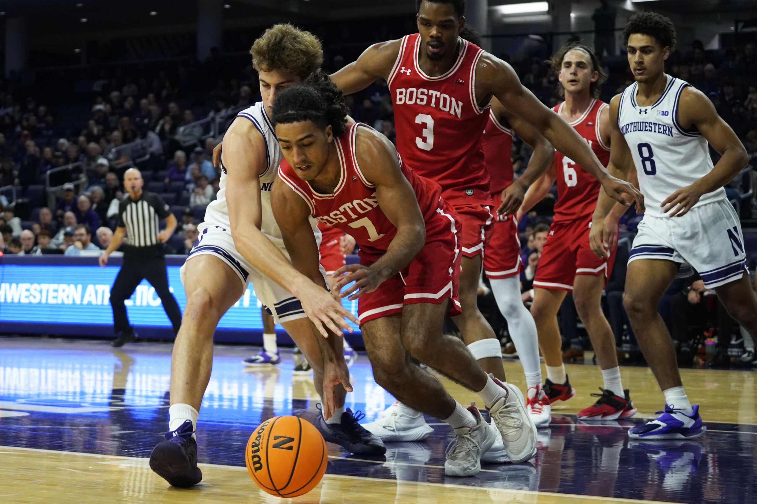 Nov 7, 2025; Evanston, Illinois, USA; Boston University Terriers guard Azmar Abdullah (7) and Northwestern Wildcats forward Tyler Kropp (1) go for a loose ball during the first half at Welsh-Ryan Arena. Mandatory Credit: David Banks-Imagn Images