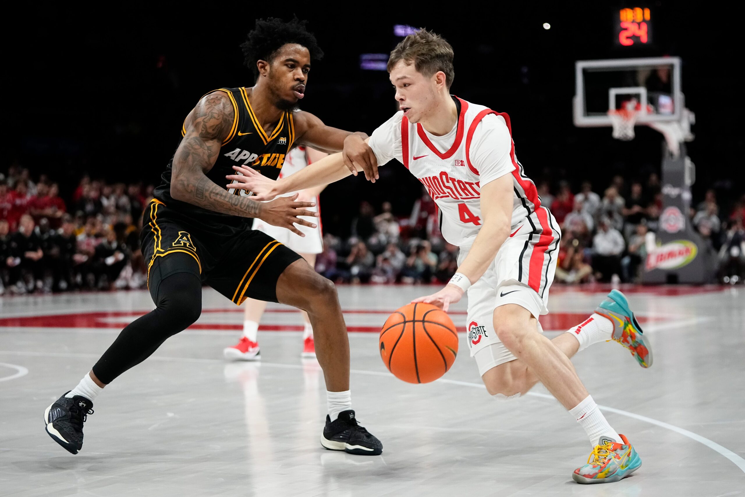 Ohio State Buckeyes guard Gabe Cupps (4) dribbles by Appalachian State Mountaineers guard Kasen Jennings (13) during the NCAA men's basketball game at Value City Arena in Columbus on Nov. 11, 2025. Ohio State won 75-53.