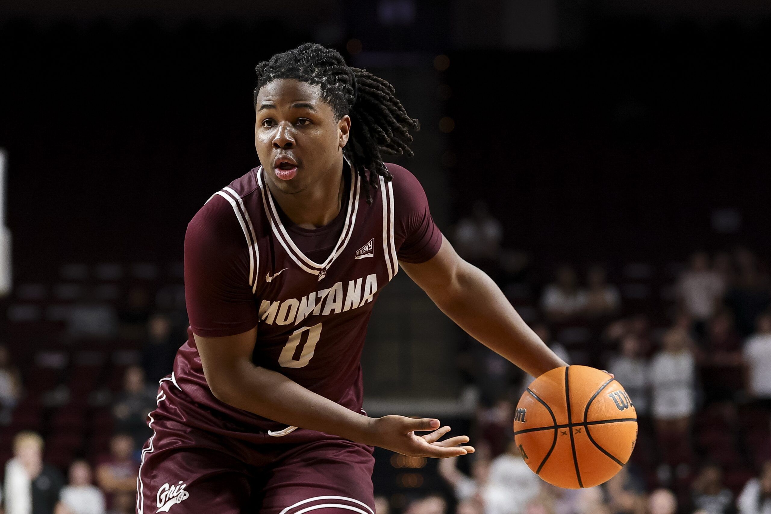 Nov 18, 2025; College Station, Texas, USA; Montana Grizzlies guard Money Williams (0) looks to pass the ball during the second half against the Texas A&M Aggies at Reed Arena. Mandatory Credit: Maria Lysaker-Imagn Images
