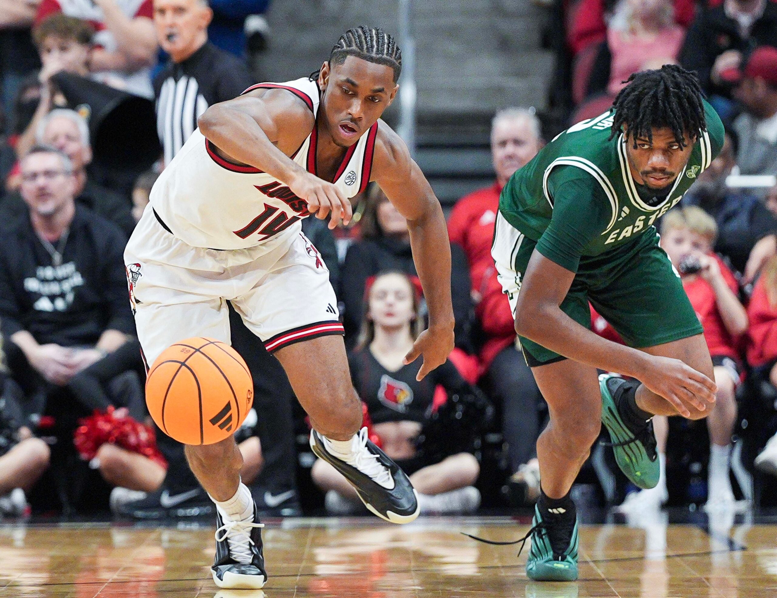 Louisville Cardinals guard Adrian Wooley (14) steals the ball from Eastern Michigan Eagles guard Carlos Hart (2) in the second half. The Cards beat the Eagles 87-46 Monday night, Nov. 24, 2025 at the KFC Yum! Center in Louisville, Kentucky.