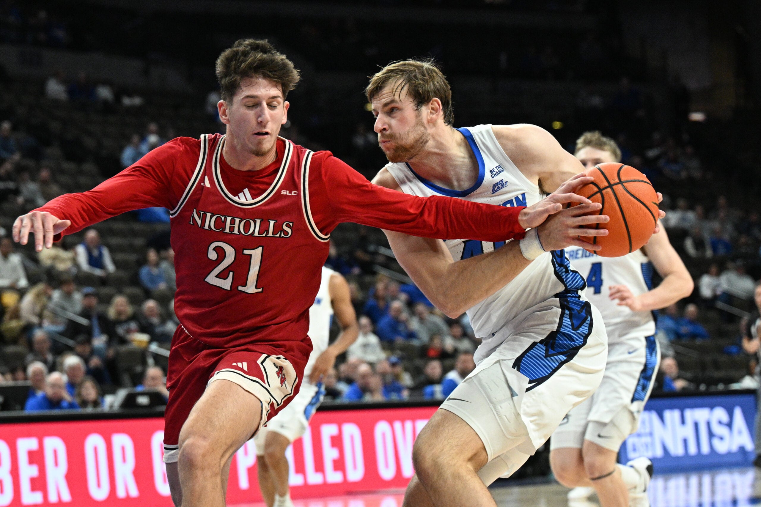 Dec 2, 2025; Omaha, Nebraska, USA;  Creighton Bluejays forward Isaac Traudt (41) drives against Nicholls State Colonels guard Nick Krass (21) during the second half at CHI Health Center Omaha. Mandatory Credit: Steven Branscombe-Imagn Images
