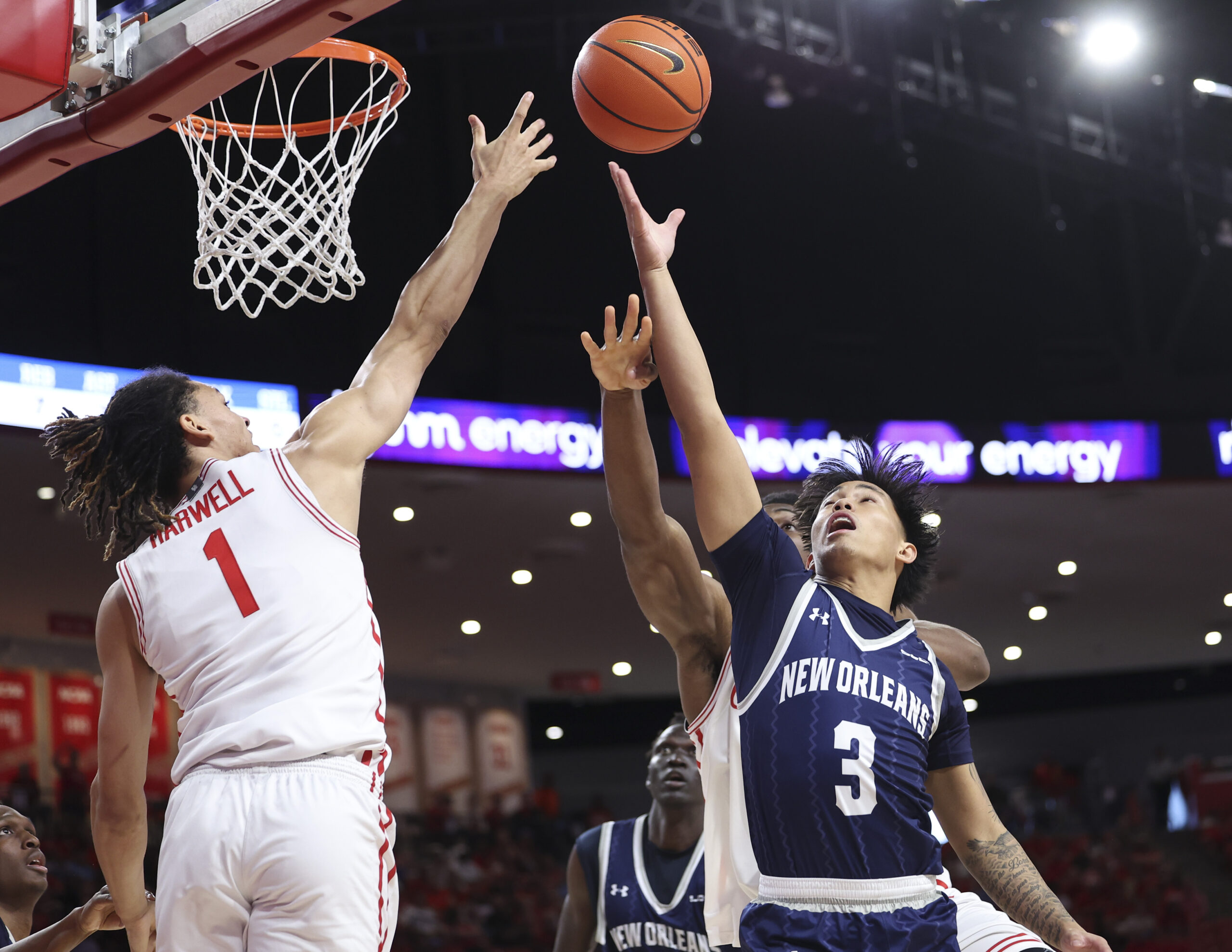 Dec 13, 2025; Houston, Texas, USA; Houston Cougars guard Isiah Harwell (1) and New Orleans Privateers guard Irish Coquia (3) battle for a loose ball during the first half at Fertitta Center. Mandatory Credit: Troy Taormina-Imagn Images