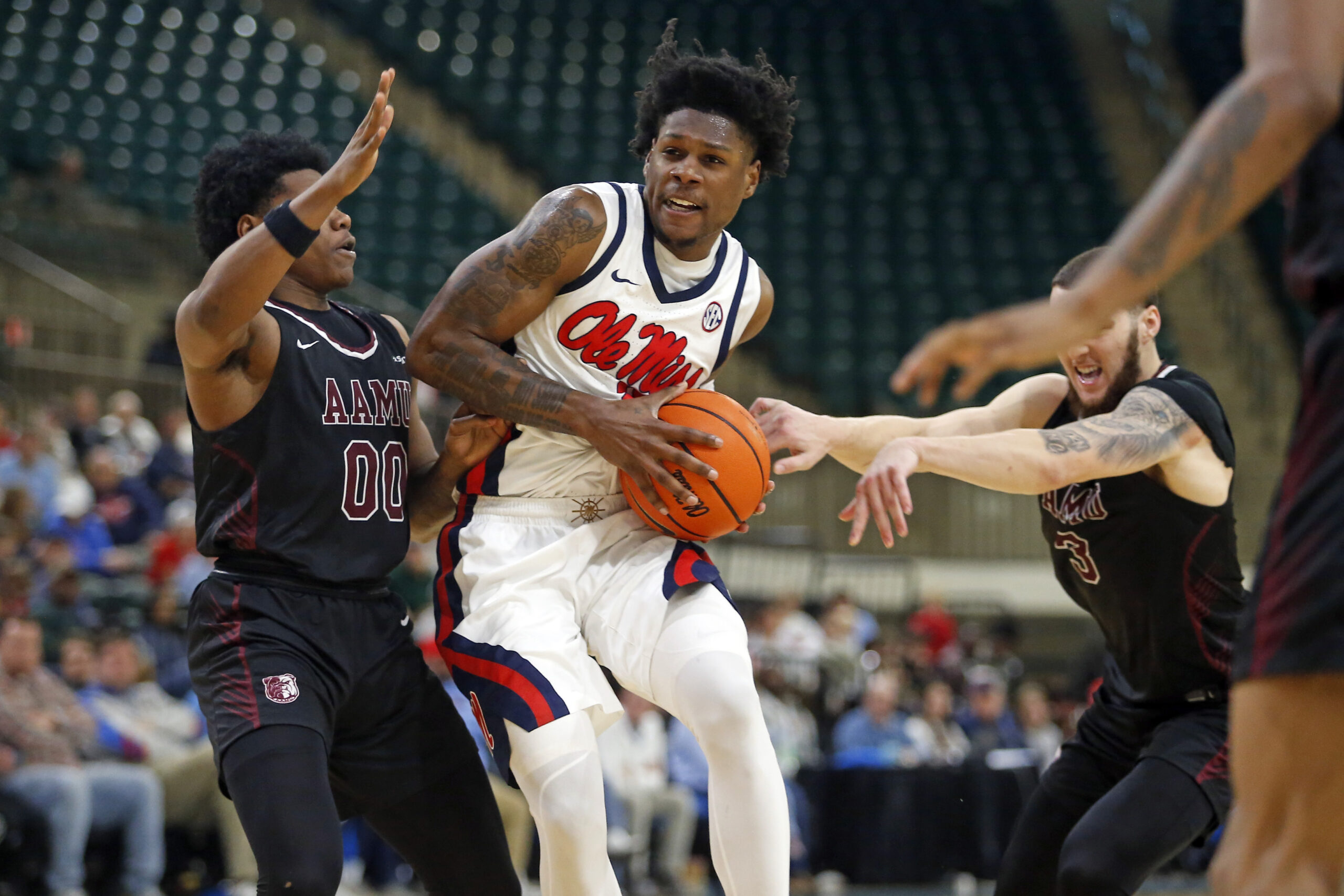 Dec 17, 2025; Tupelo, Mississippi, USA; Mississippi Rebels guard AJ Storr (2) drives to the basket as Alabama A&M Bulldogs guard Kintavious Dozier (00) defends during the second half at Cadence Bank Arena. Mandatory Credit: Petre Thomas-Imagn Images