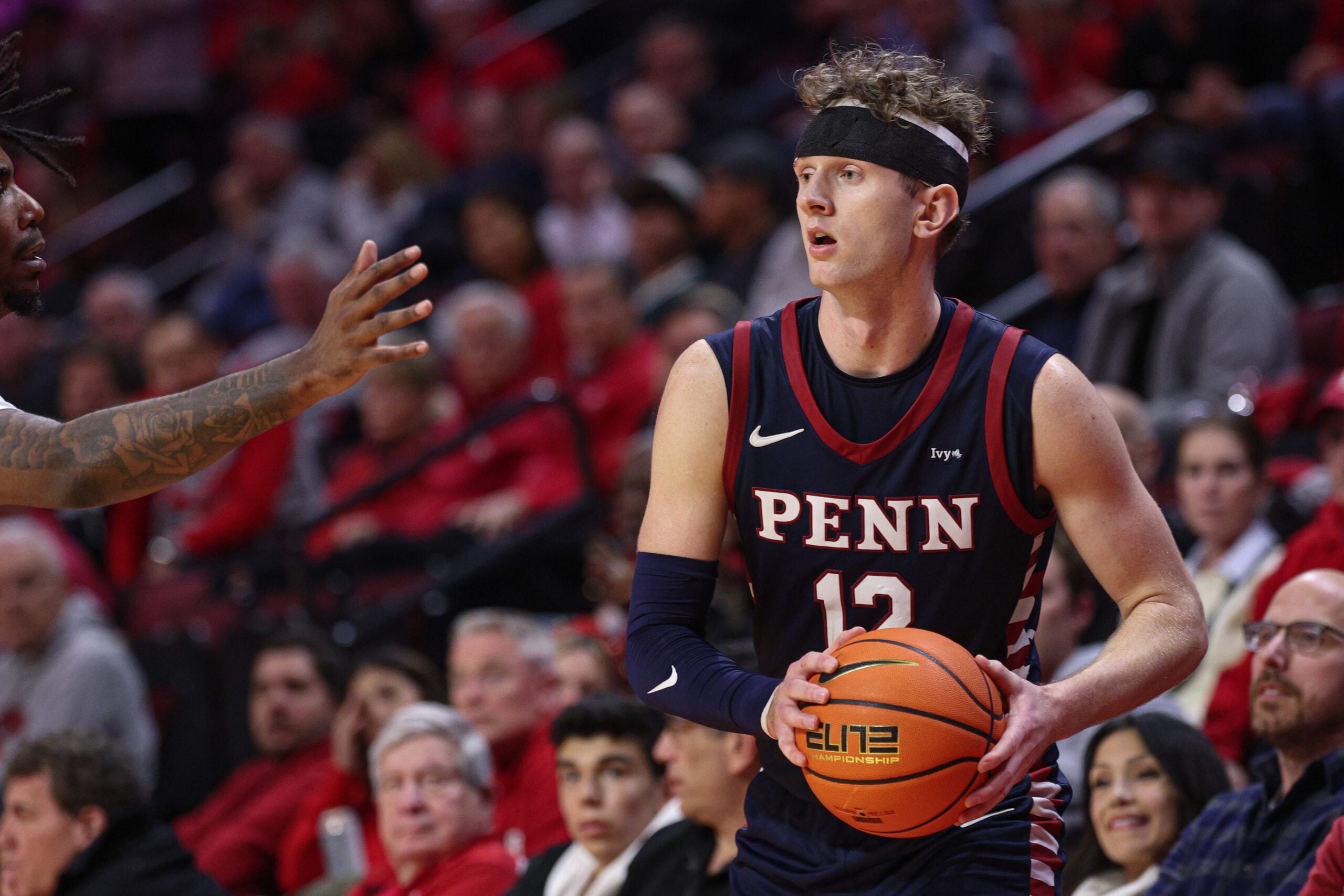 Dec 20, 2025; Piscataway, New Jersey, USA; Penn Quakers forward TJ Power (12) looks to pass during the second half against the Rutgers Scarlet Knights at Jersey Mike's Arena. Mandatory Credit: Vincent Carchietta-Imagn Images
