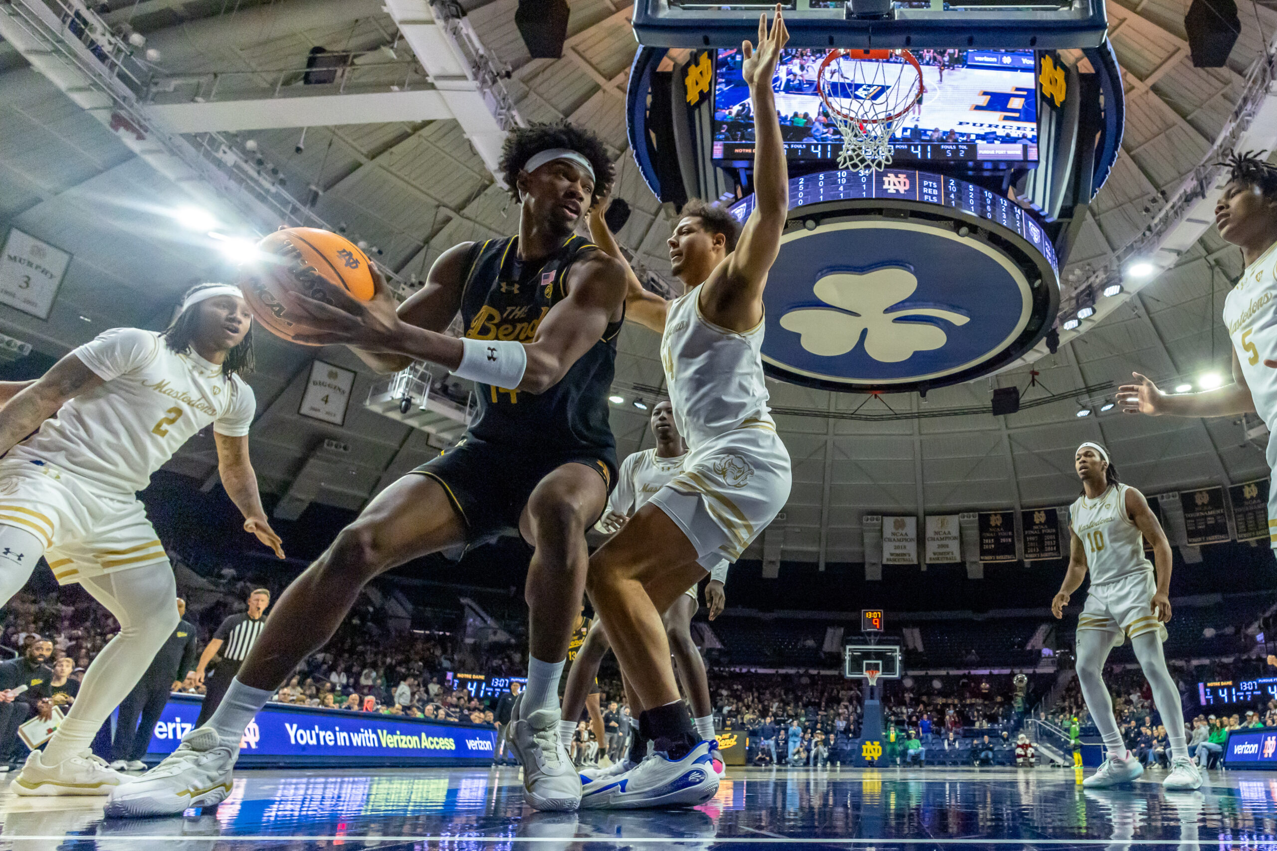 Dec 21, 2025; South Bend, Indiana, USA; Notre Dame Fighting Irish forward Kebba Njie (14) looks to pass as Purdue Fort Wayne Mastodons forward Darius Duffy (34) defends him during the second half at Purcell Pavilion at the Joyce Center. Mandatory Credit: Michael Caterina-Imagn Images