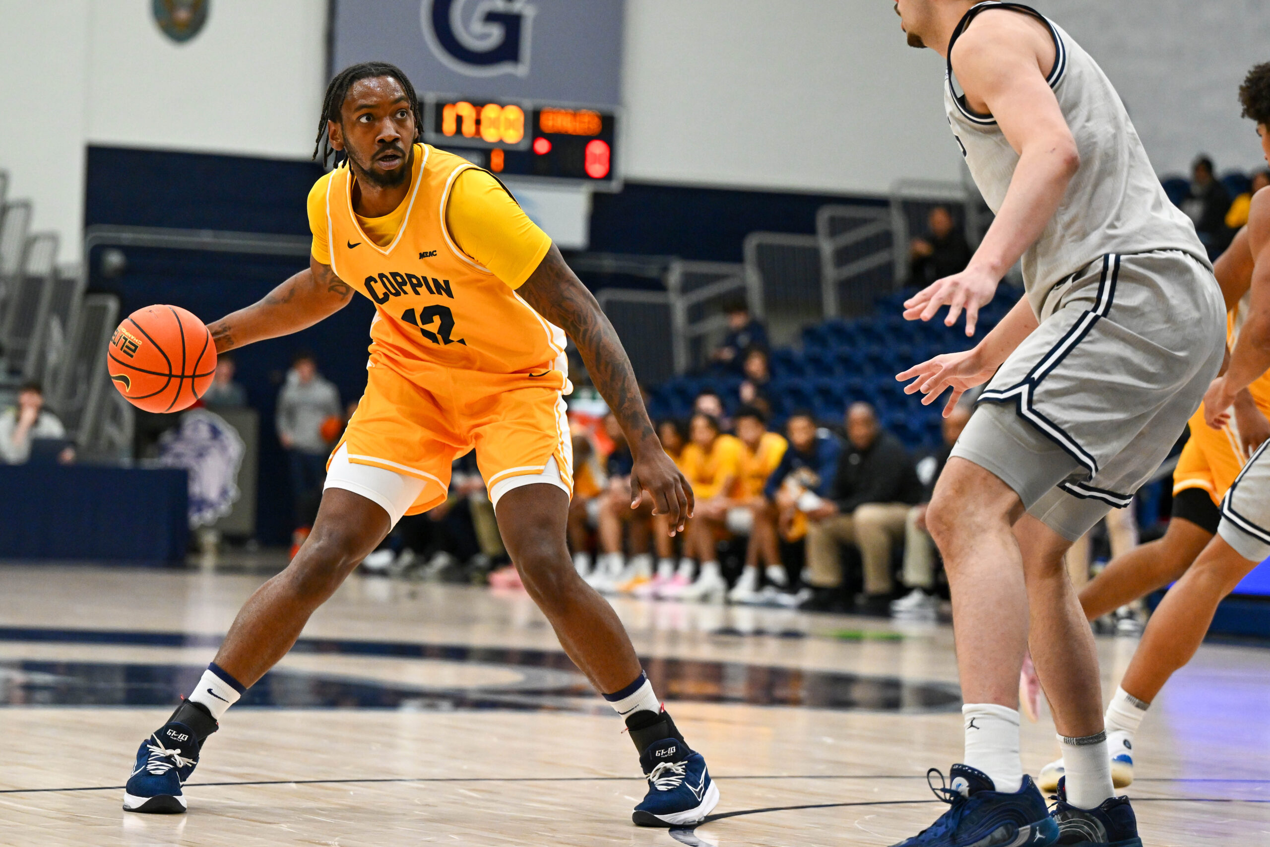 Dec 22, 2025; Washington, District of Columbia, USA; Coppin State Eagles forward Chris Morgan (12) looks to pass as Georgetown Hoyas center Julius Halaifonua (11) defends during the first half at McDonough Arena. Mandatory Credit: Brad Mills-Imagn Images