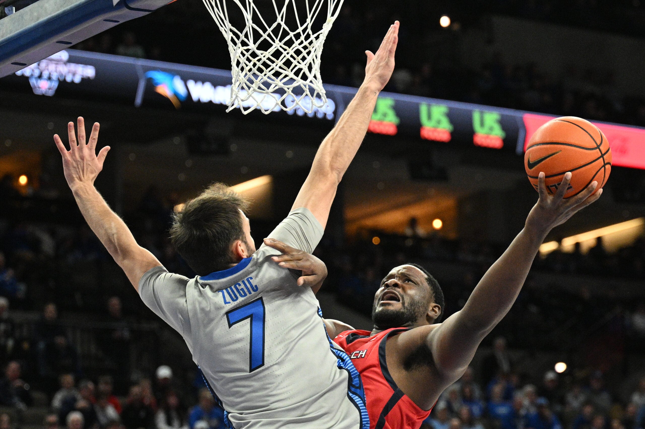 Dec 22, 2025; Omaha, Nebraska, USA;  Utah Tech Trailblazers forward Dario Domingos (52) attempts a shot over Creighton Bluejays guard Fedor Zugic (7) during the first half at CHI Health Center Omaha. Mandatory Credit: Steven Branscombe-Imagn Images