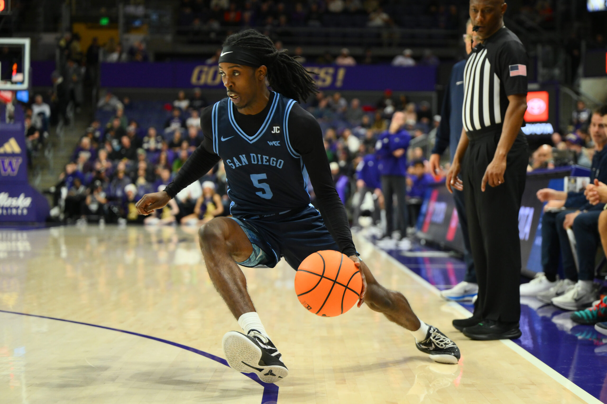 Dec 22, 2025; Seattle, Washington, USA; San Diego Toreros guard Ty-Laur Johnson (5) dribbles the ball during the second half against the Washington Huskies at Alaska Airlines Arena at Hec Edmundson Pavilion. Mandatory Credit: Steven Bisig-Imagn Images