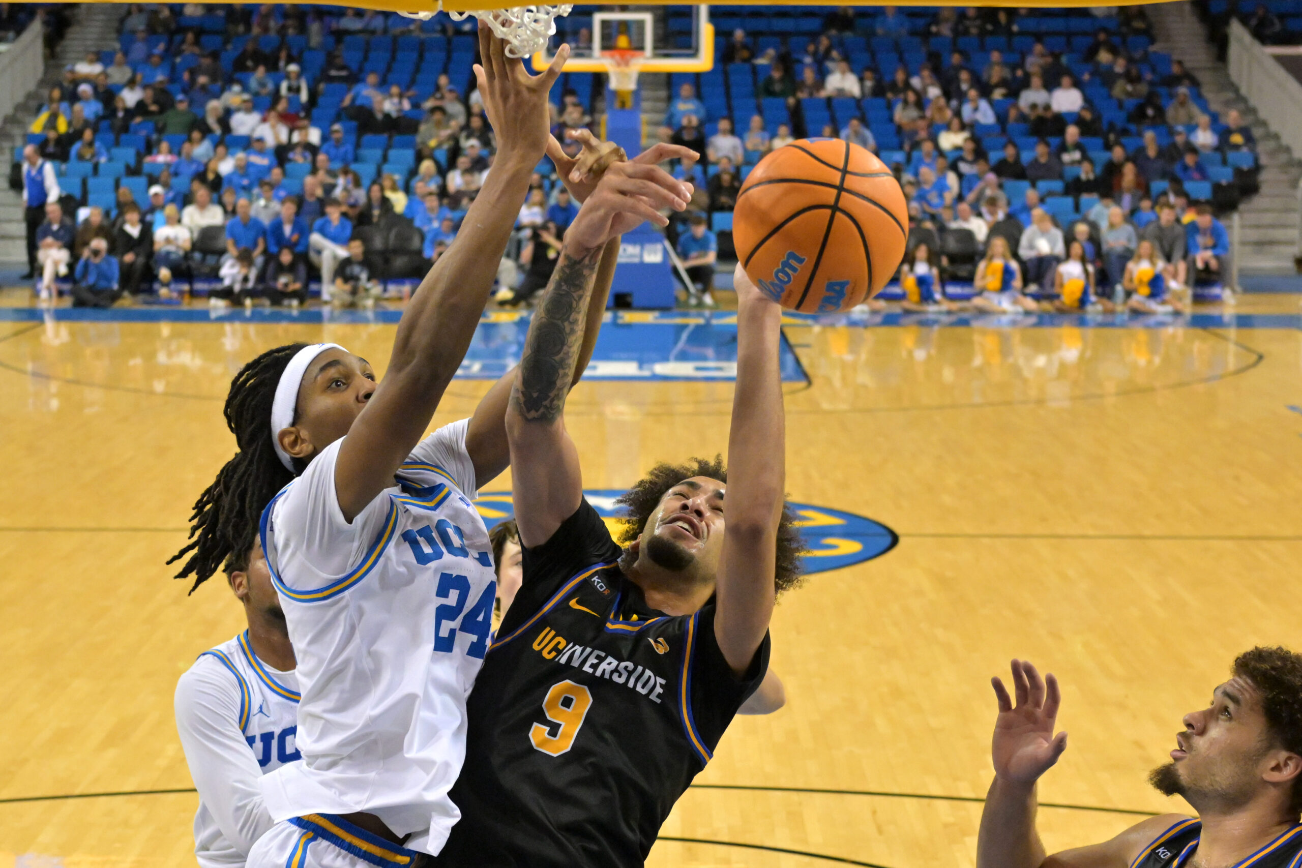 Dec 23, 2025; Los Angeles, California, USA; UCLA Bruins center Steven Jamerson II (24) defends a shot by UC Riverside Highlanders forward Osiris Grady (9) in the second half at Pauley Pavilion presented by Wescom Financial. Mandatory Credit: Jayne Kamin-Oncea-Imagn Images