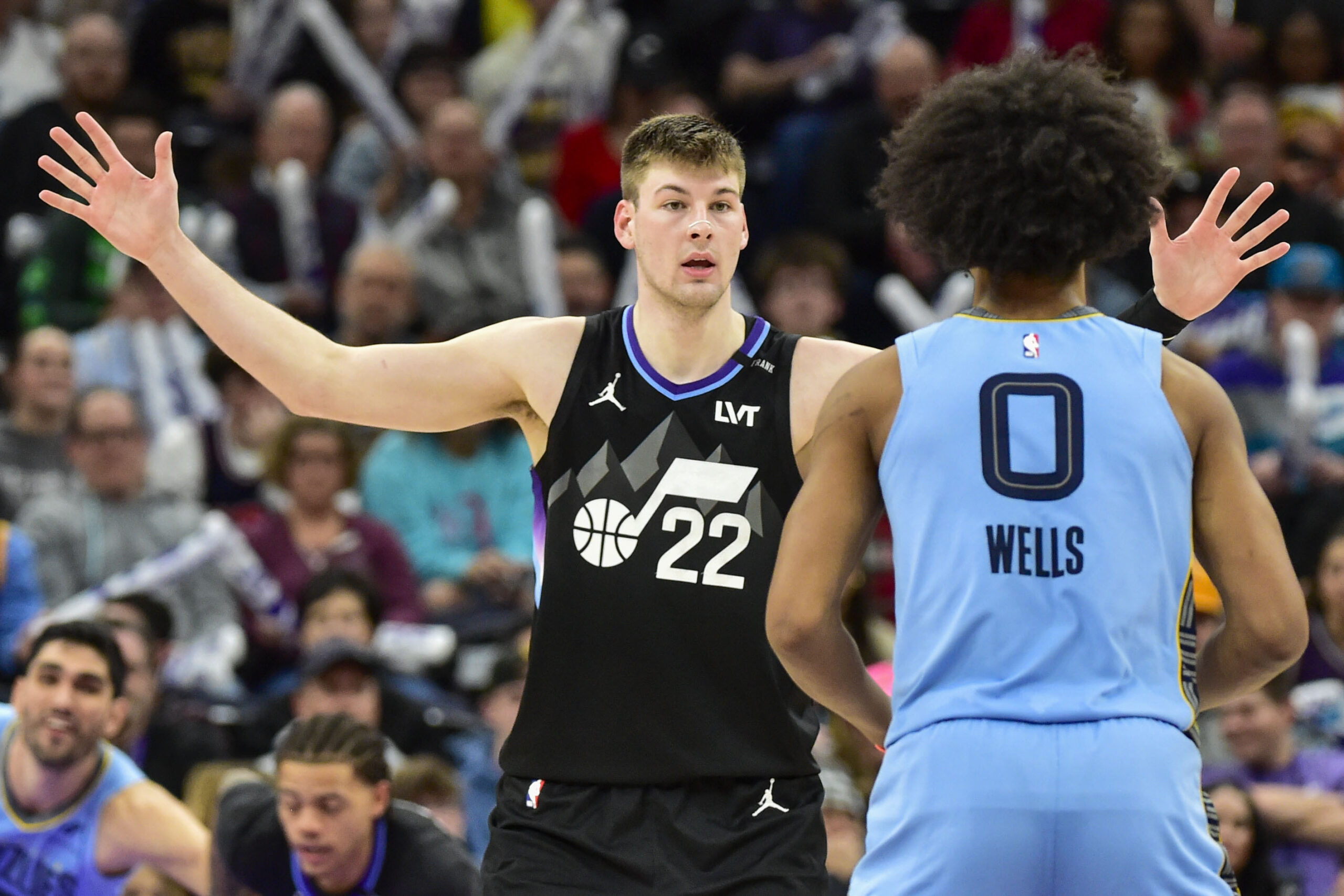 Dec 23, 2025; Salt Lake City, Utah, USA; Utah Jazz center Kyle Filipowski (22) defends the pass from Memphis Grizzlies forward Jaylen Wells (0) during the second half at Delta Center. Mandatory Credit: Peter Creveling-Imagn Images
