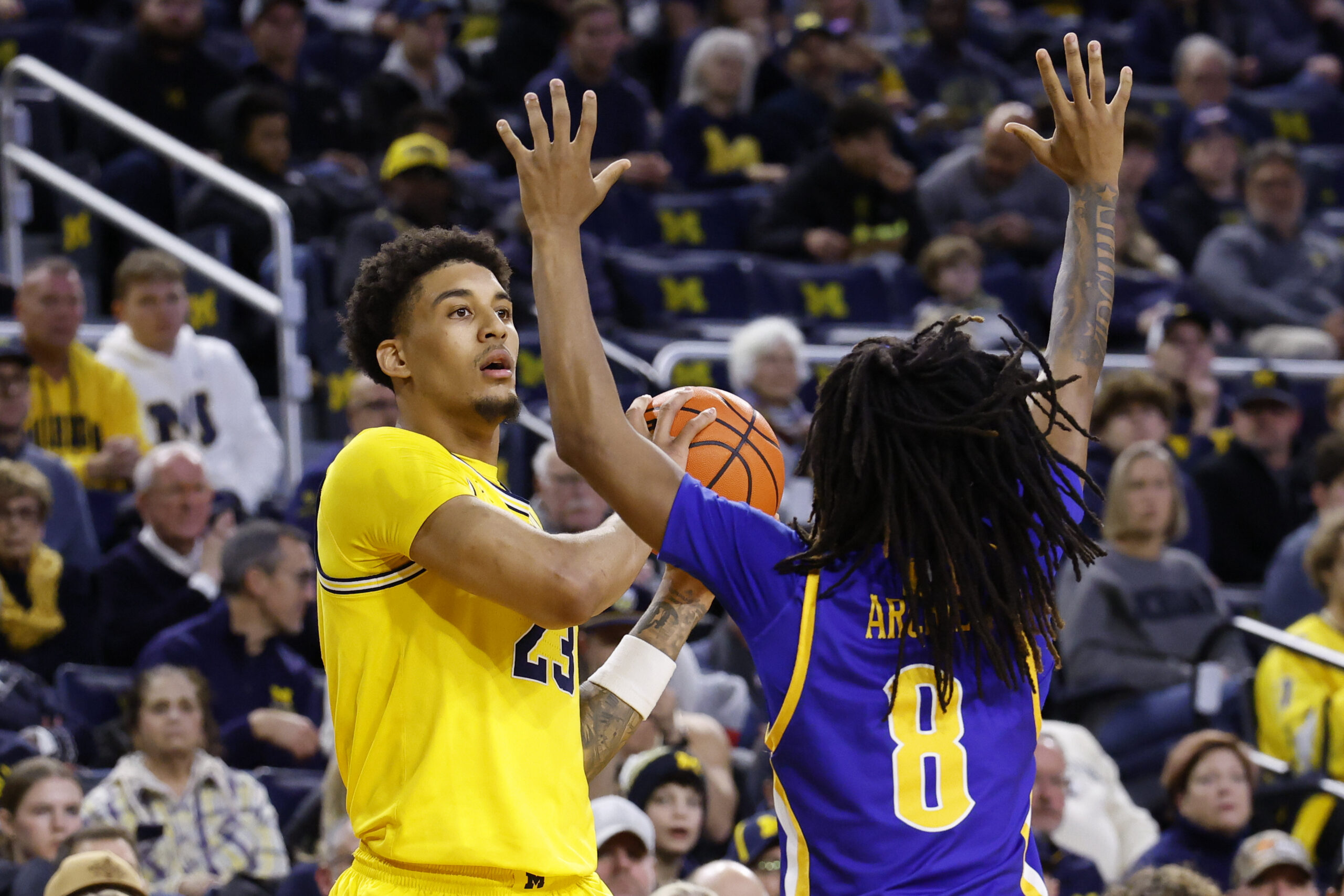 Dec 29, 2025; Ann Arbor, Michigan, USA;  Michigan Wolverines forward Yaxel Lendeborg (23) is defended by McNeese Cowboys guard Tyshawn Archie (8) in the first half at Crisler Center. Mandatory Credit: Rick Osentoski-Imagn Images