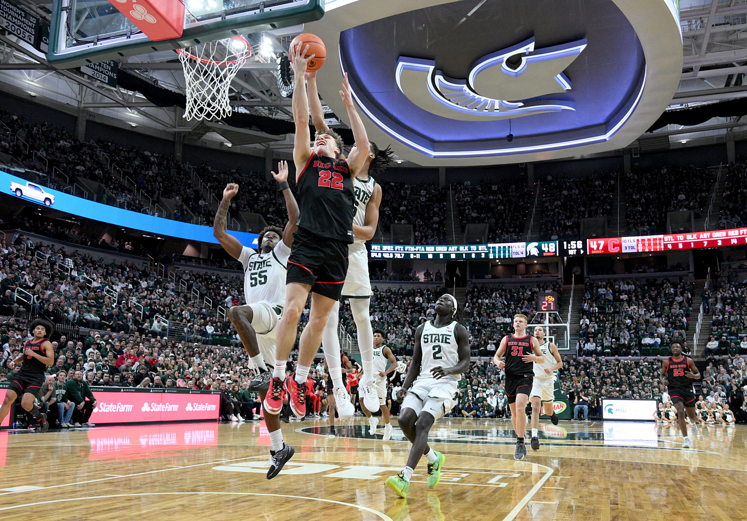 Dec 29, 2025; East Lansing, Michigan, USA;  Cornell Big Red guard Jake Fiegen (22) gets his layup blocked by Michigan State Spartans forward Jordan Scott (6) during the first half at Jack Breslin Student Events Center. Mandatory Credit: Dale Young-Imagn Images