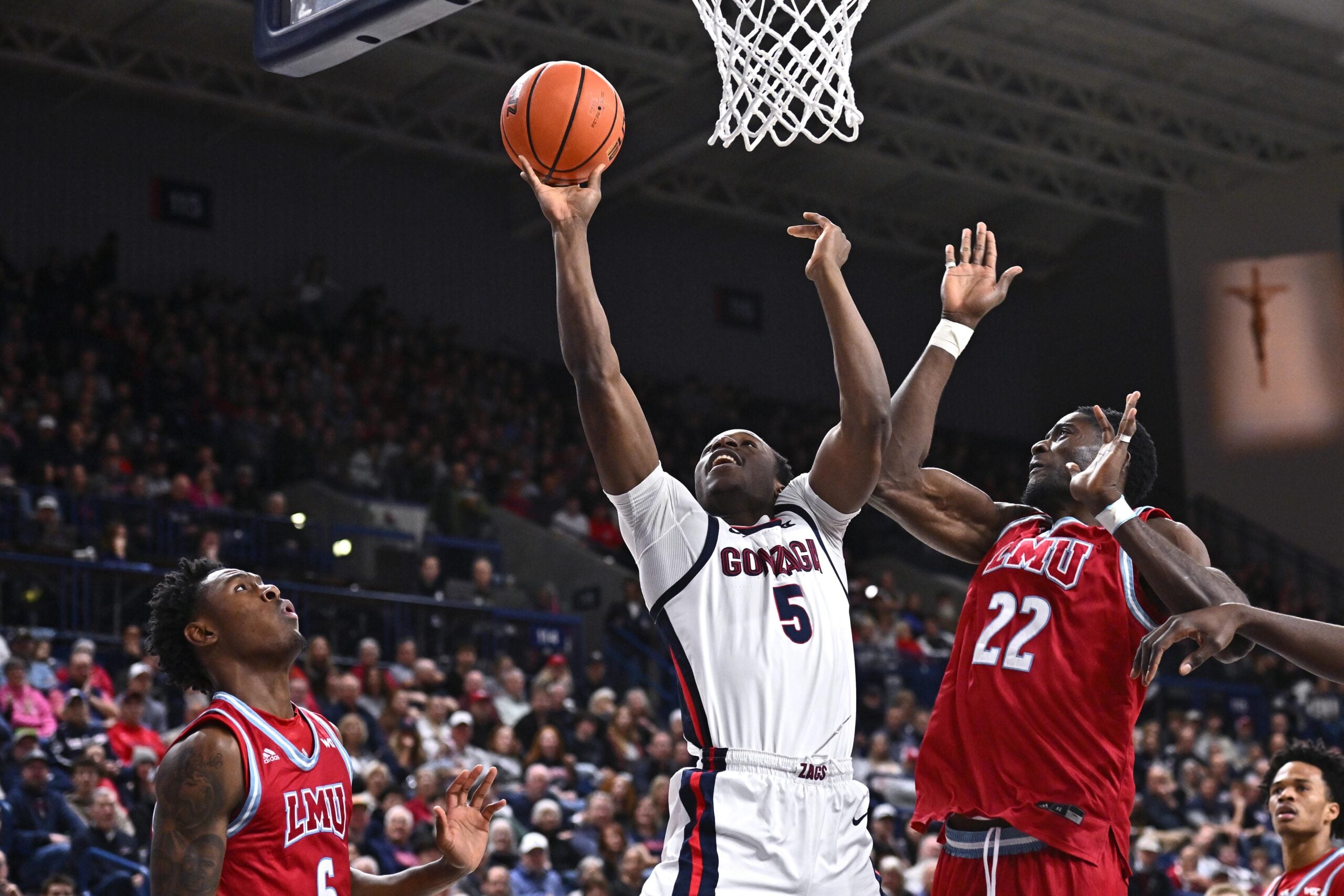 Jan 4, 2026; Spokane, Washington, USA; Gonzaga Bulldogs forward Emmanuel Innocenti (5) shoots the ball agaisnt Loyola Marymount Lions center Rick Issanza (22) in the second half at McCarthey Athletic Center. Mandatory Credit: James Snook-Imagn Images