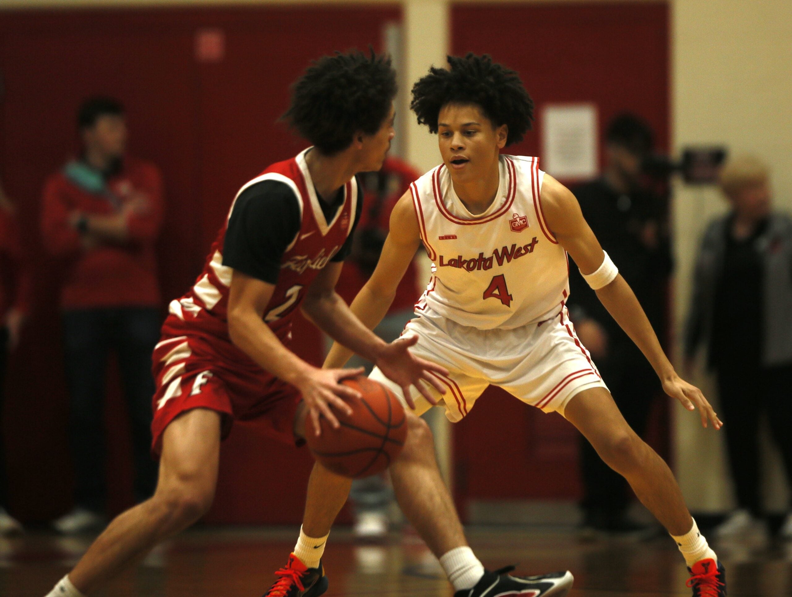 Lakota West junior Parker Robinson (4) keeps a close eye on Fairfield senior Cam Arington (2) as Lakota West defeated Fairfield, 58-41 in OHSAA boys basketball Jan. 9, 2026 at Lakota West.