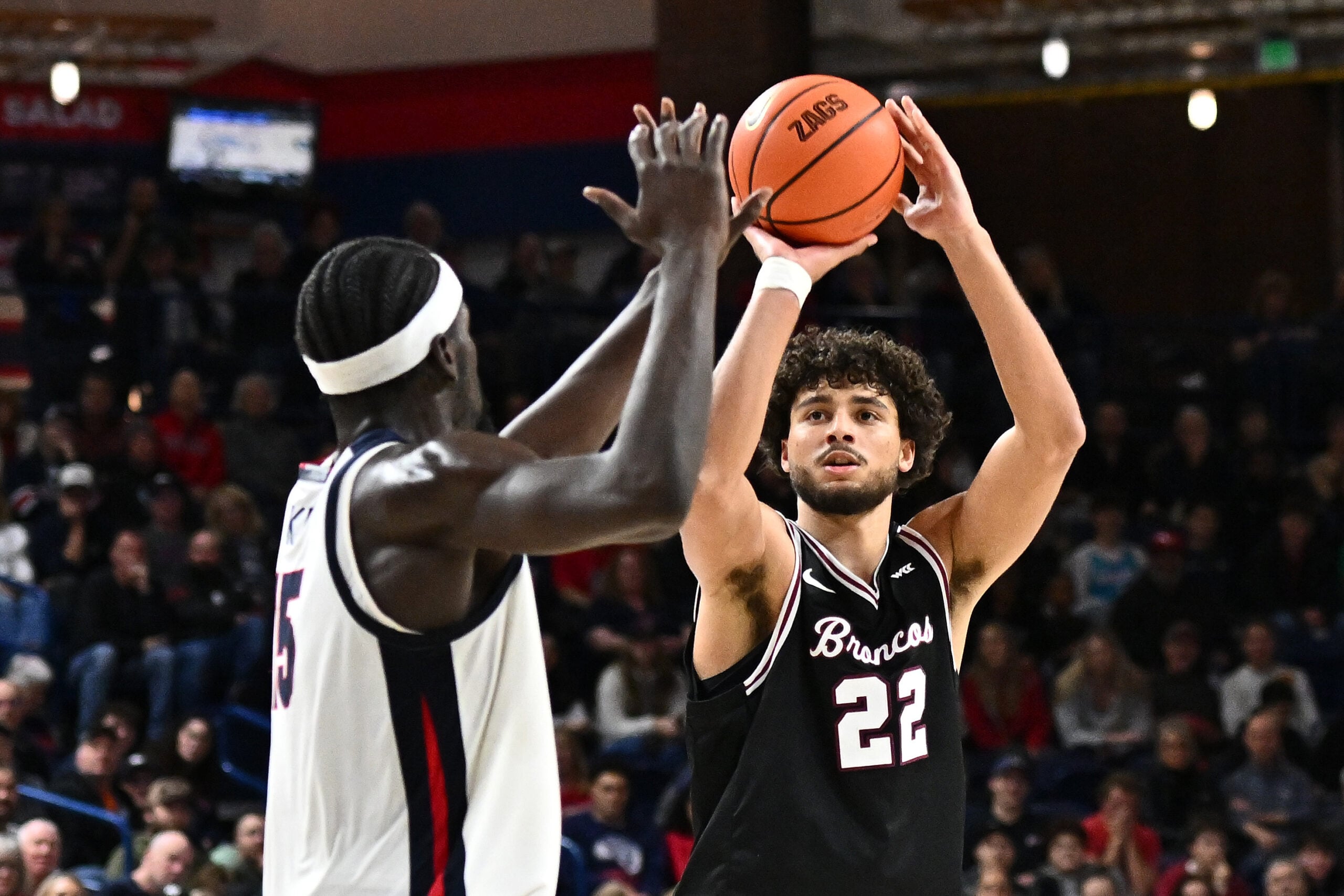 Jan 8, 2026; Spokane, Washington, USA; Santa Clara Broncos forward Allen Graves (22) shoots the ball against Gonzaga Bulldogs forward Graham Ike (15) in the second half at McCarthey Athletic Center. Mandatory Credit: James Snook-Imagn Images