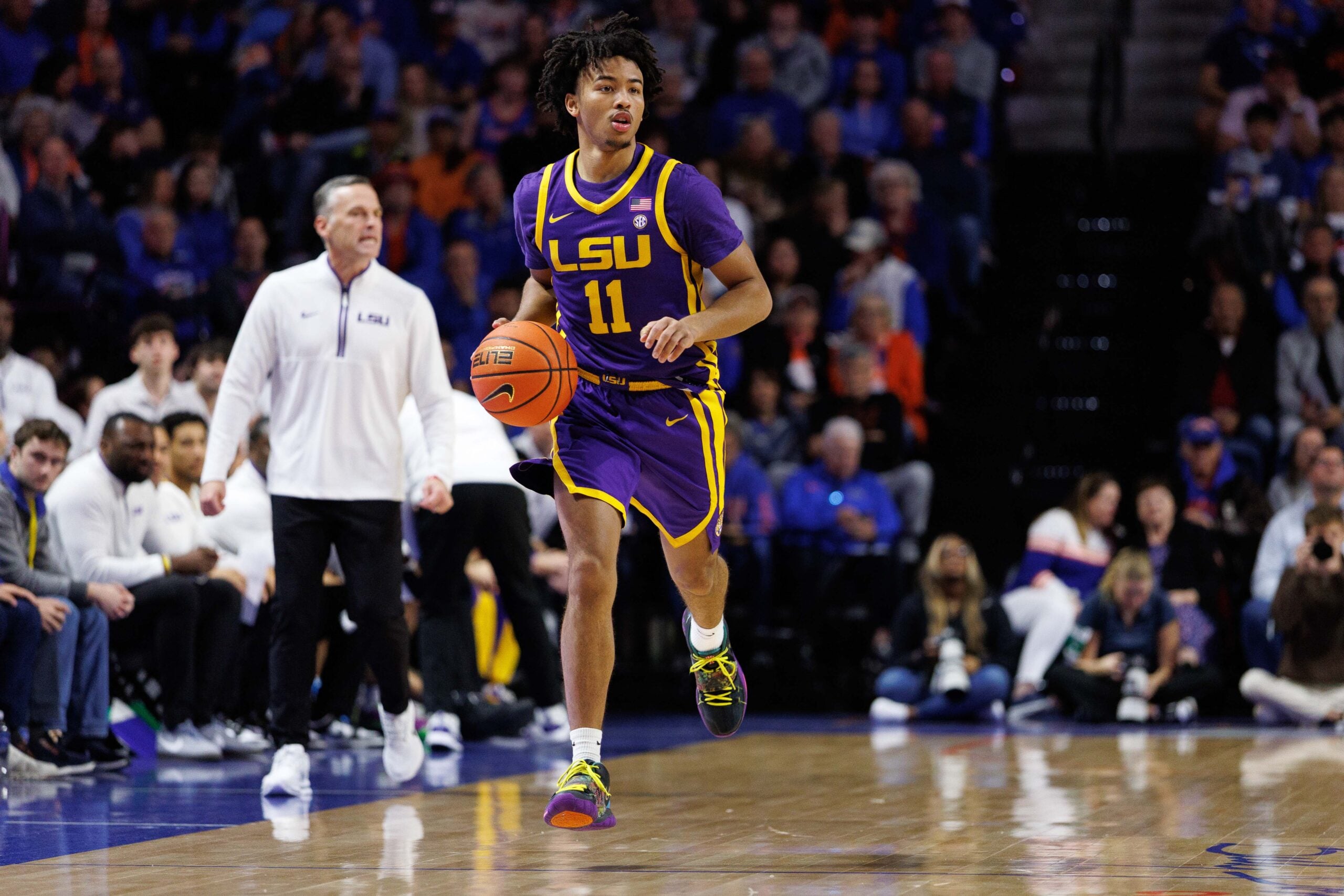 Jan 20, 2026; Gainesville, Florida, USA; Louisiana State Tigers guard Dedan Thomas Jr. (11) dribbles the ball against the Florida Gators during the first half at Exactech Arena at the Stephen C. O'Connell Center. Mandatory Credit: Matt Pendleton-Imagn Images