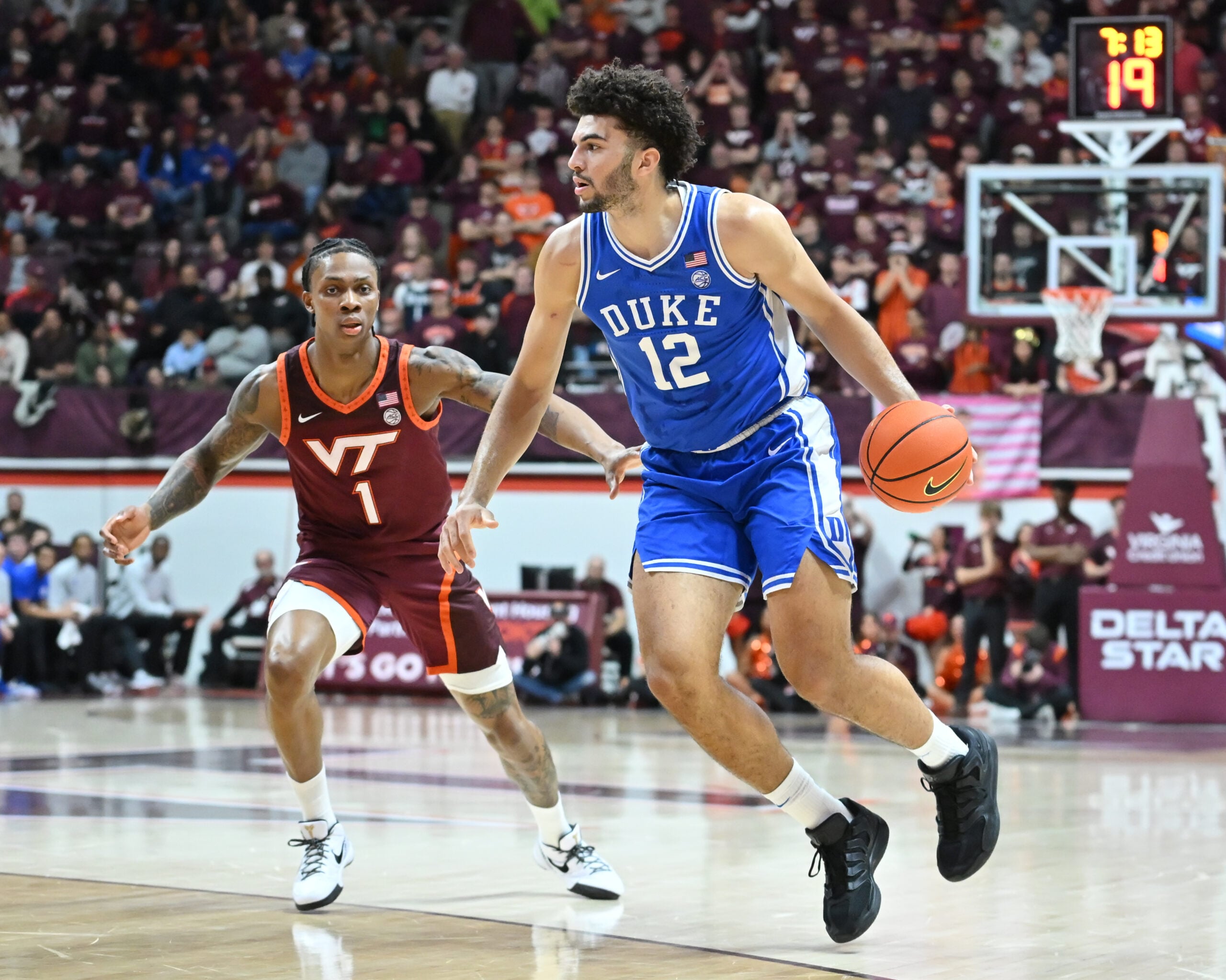 Jan 31, 2026; Blacksburg, Virginia, USA; Duke Blue Devils forward Cameron Boozer (12) controls the ball as Virginia Tech Hokies forward Tobi Lawal (1) defends during the first half at Cassell Coliseum. Mandatory Credit: Brian Bishop-Imagn Images