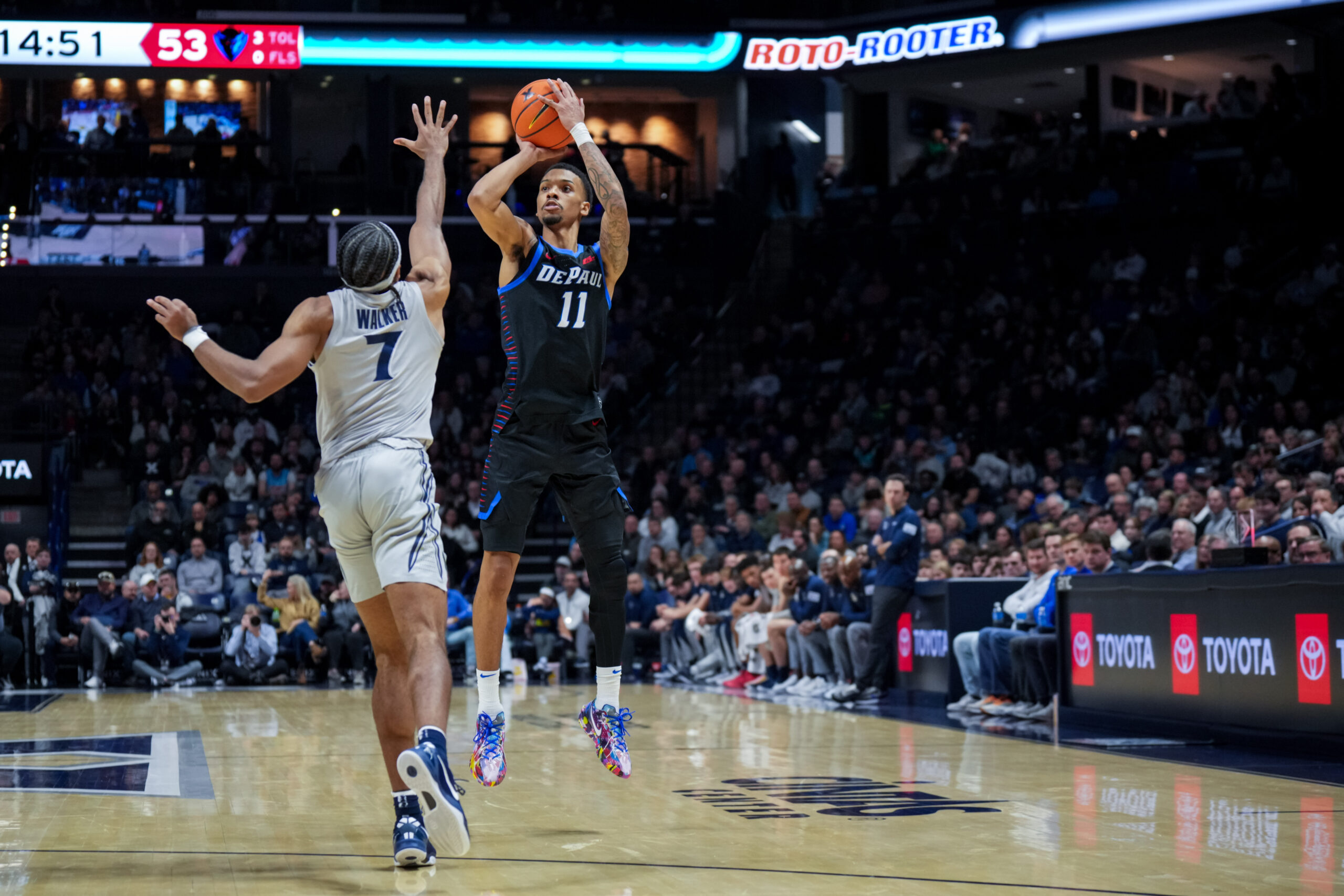 Jan 31, 2026; Cincinnati, Ohio, USA; DePaul Blue Demons guard CJ Gunn (11) attempts a 3-point shot against Xavier Musketeers guard Isaiah Walker (7) in the second half at the Cintas Center. Mandatory Credit: Aaron Doster-Imagn Images