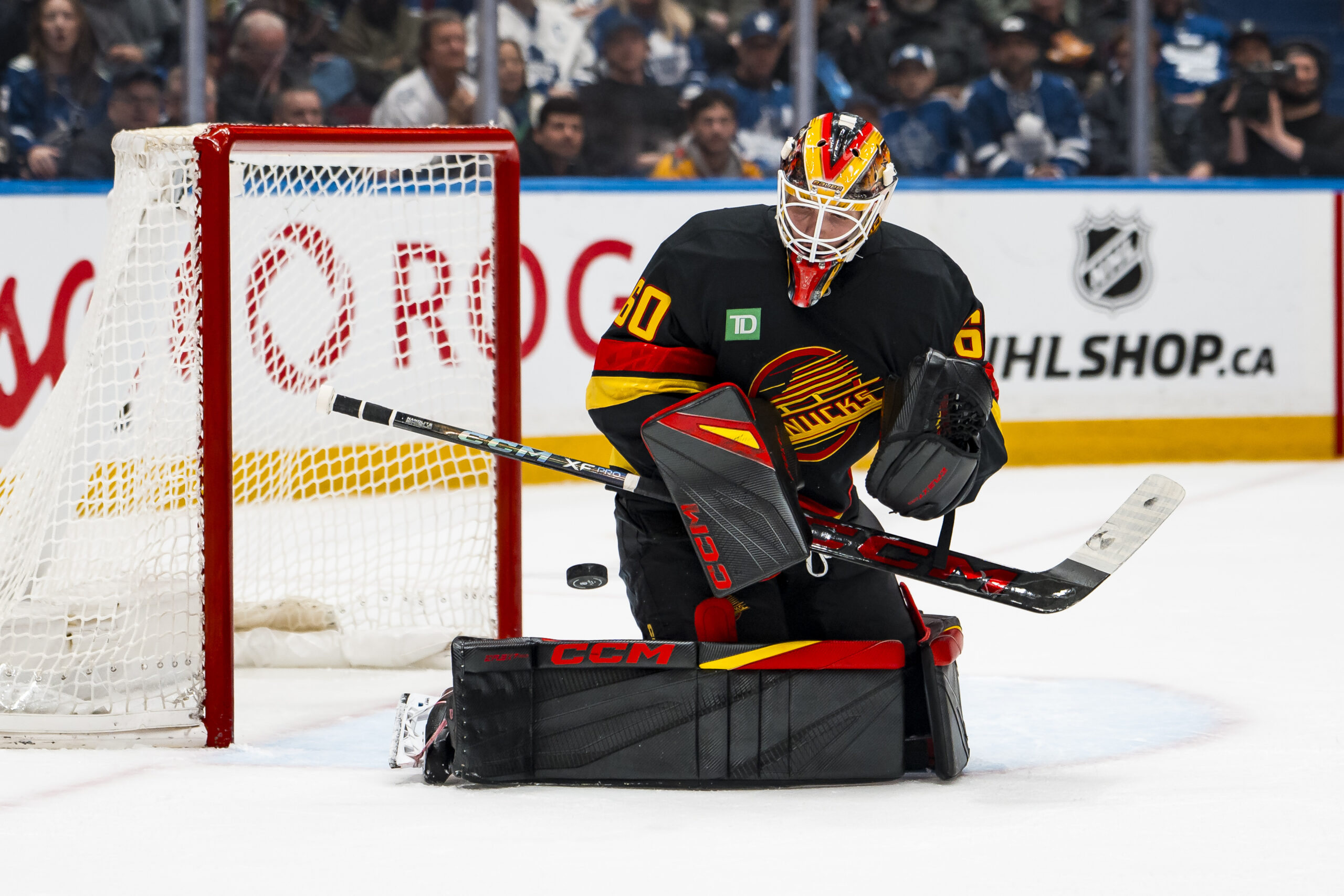 Jan 31, 2026; Vancouver, British Columbia, CAN; Vancouver Canucks goalie Nikita Tolopilo (60) makes a save against the Toronto Maple Leafs in the third period at Rogers Arena. Mandatory Credit: Bob Frid-Imagn Images