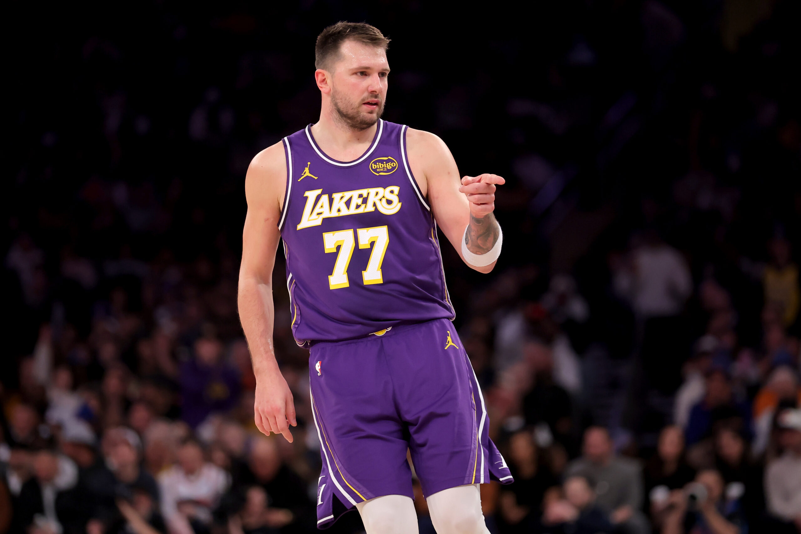 Feb 1, 2026; New York, New York, USA; Los Angeles Lakers guard Luka Doncic (77) points in the direction of Knicks fan Spike Lee (not pictured) after a three point shot against the New York Knicks during the third quarter at Madison Square Garden. Mandatory Credit: Brad Penner-Imagn Images