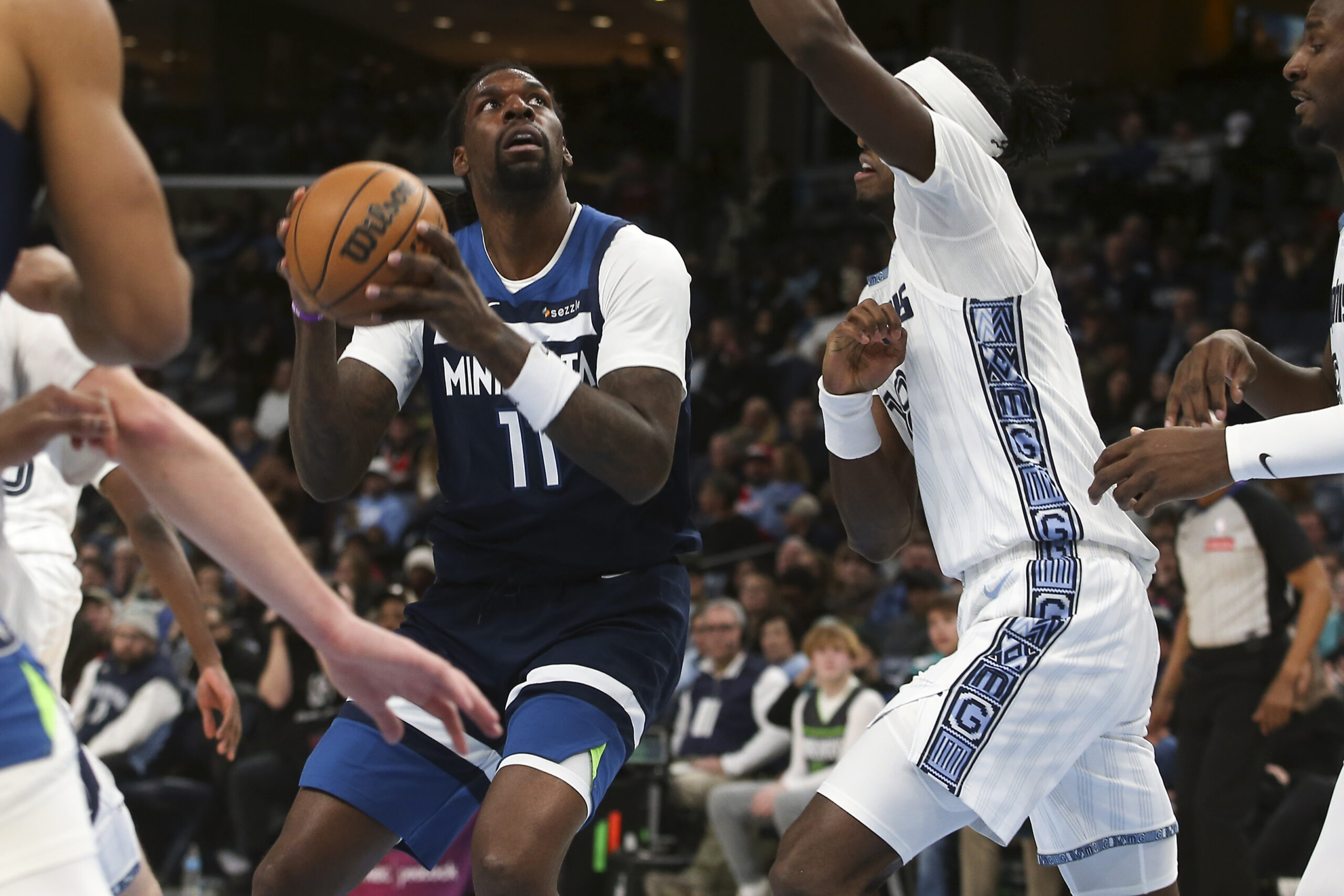 Feb 2, 2026; Memphis, Tennessee, USA; Minnesota Timberwolves center Naz Reid (11) drives to the basket as Memphis Grizzlies forward Olivier-Maxence Prosper (18) defends during the fourth quarter at FedExForum. Mandatory Credit: Petre Thomas-Imagn Images