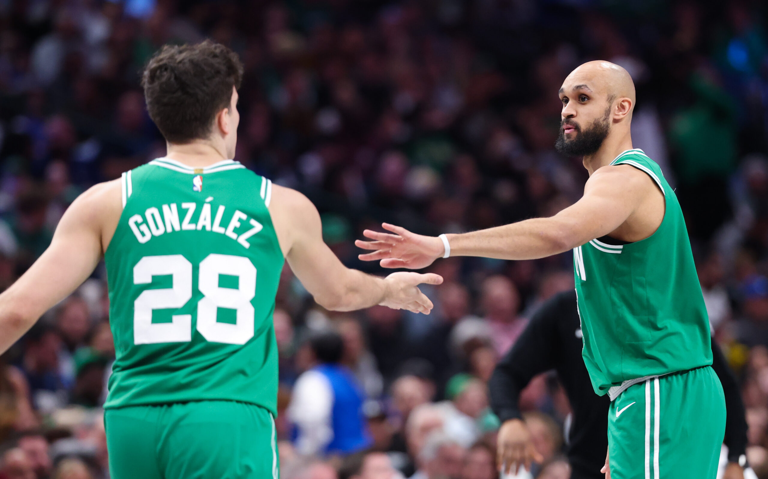 Feb 3, 2026; Dallas, Texas, USA; Boston Celtics guard Derrick White (9) celebrates with Boston Celtics guard Hugo Gonzalez (28) during the second half against the Dallas Mavericks at American Airlines Center. Mandatory Credit: Kevin Jairaj-Imagn Images