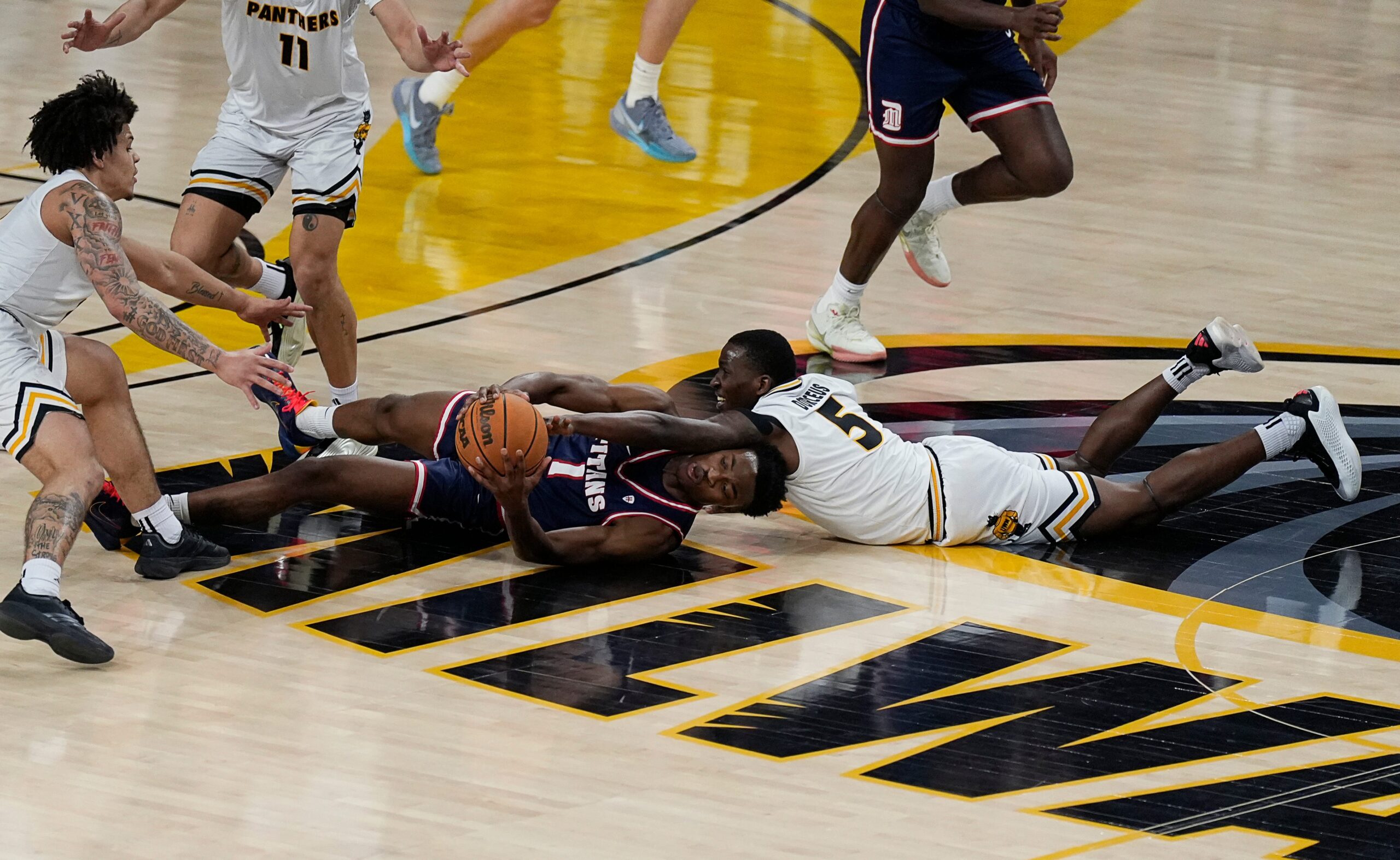 Milwaukee Panthers guard Isaiah Dorceus (5) and Detroit Mercy Titans guard Tyler Spratt (1) try to gain possession of the ball during the first half of the game on Wednesday February 4, 2026 at the UW-Milwaukee Panther Arena in Milwaukee, Wisconsin.