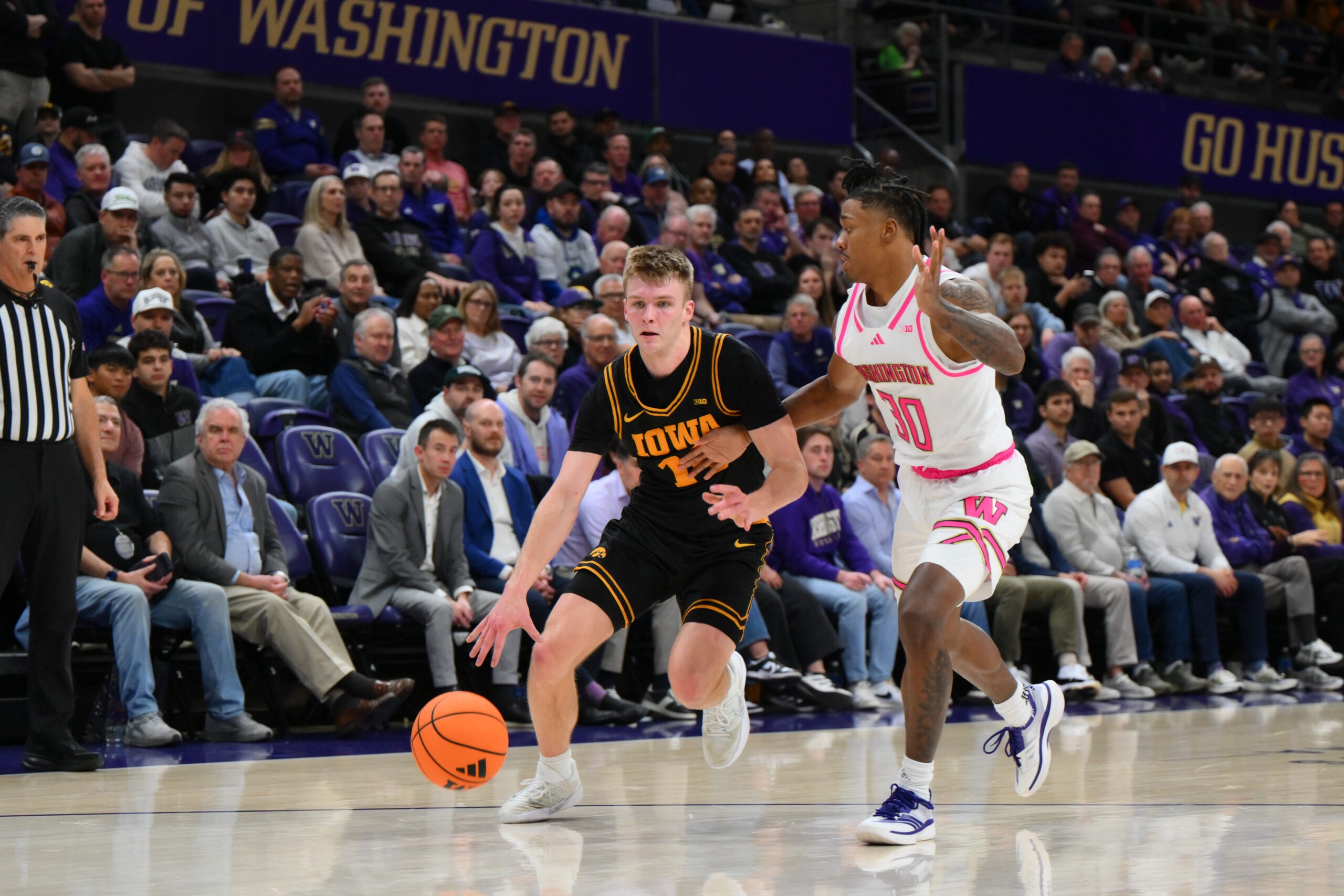 Feb 4, 2026; Seattle, Washington, USA; Iowa Hawkeyes guard Bennett Stirtz (14) dribbles the ball while guarded by Washington Huskies guard Courtland Muldrew (30) during the second half at Alaska Airlines Arena at Hec Edmundson Pavilion. Mandatory Credit: Steven Bisig-Imagn Images