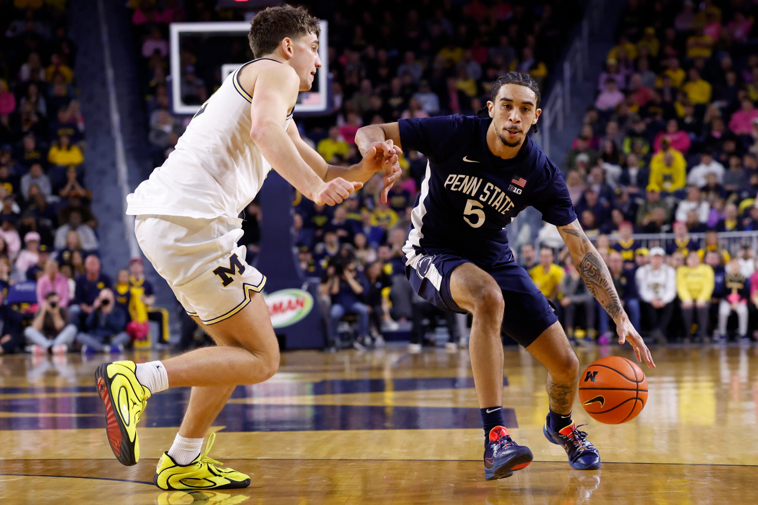 Feb 5, 2026; Ann Arbor, Michigan, USA; Penn State Nittany Lions guard Freddie Dilione V (5) dribbles against Michigan Wolverines forward Will Tschetter (42) in the second half at Crisler Center. Mandatory Credit: Rick Osentoski-Imagn Images