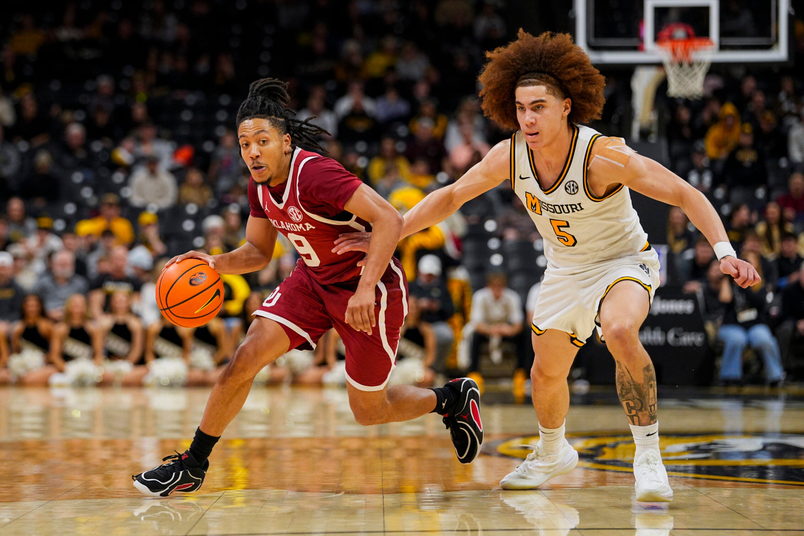 Jan 24, 2026; Columbia, Missouri, USA; Oklahoma Sooners guard Nijel Pack (9) drives against Missouri Tigers guard T.O. Barrett (5) during the second half at Mizzou Arena. Mandatory Credit: Jay Biggerstaff-Imagn Images