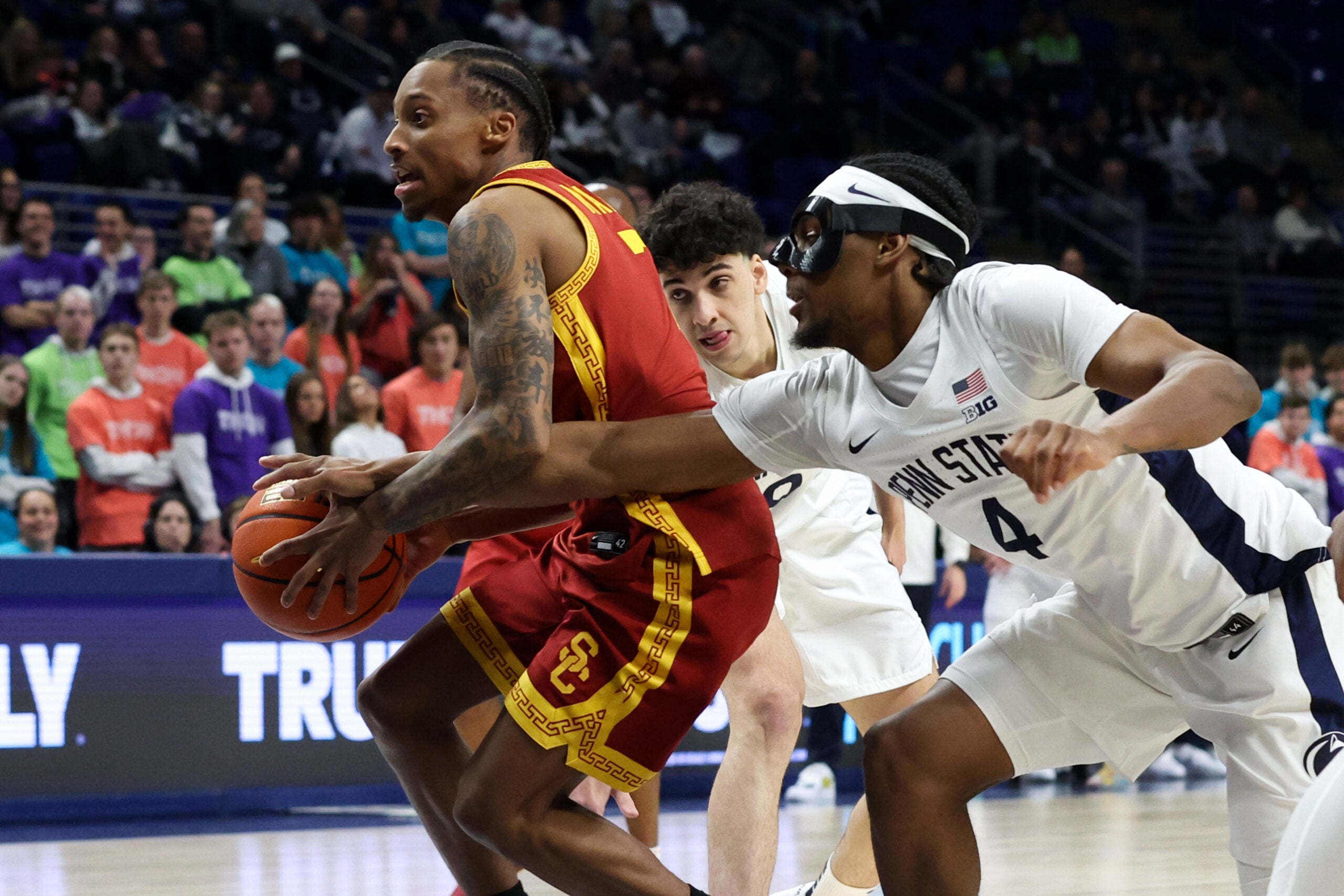 Feb 8, 2026; University Park, Pennsylvania, USA; Penn State Nittany Lions guard Kayden Mingo (4) reaches in to steal the ball away from Southern California Trojans guard Jordan Marsh (7) during the second half at Bryce Jordan Center. Mandatory Credit: Matthew O'Haren-Imagn Images