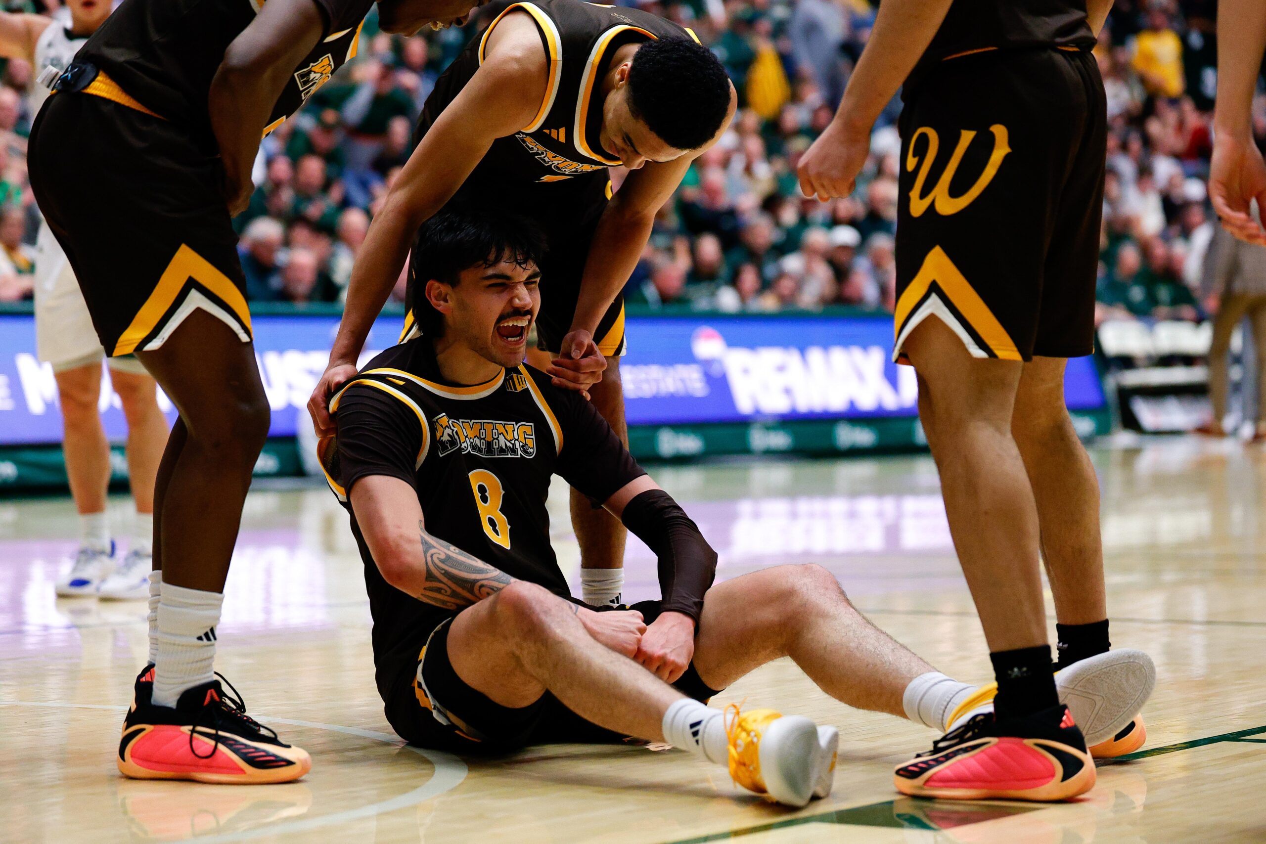 Feb 14, 2026; Fort Collins, Colorado, USA; Wyoming Cowboys forward Kiani Saxon (8) reacts with guard Damarion Dennis (1) after a play in the second half against the Colorado State Rams at Moby Arena. Mandatory Credit: Isaiah J. Downing-Imagn Images