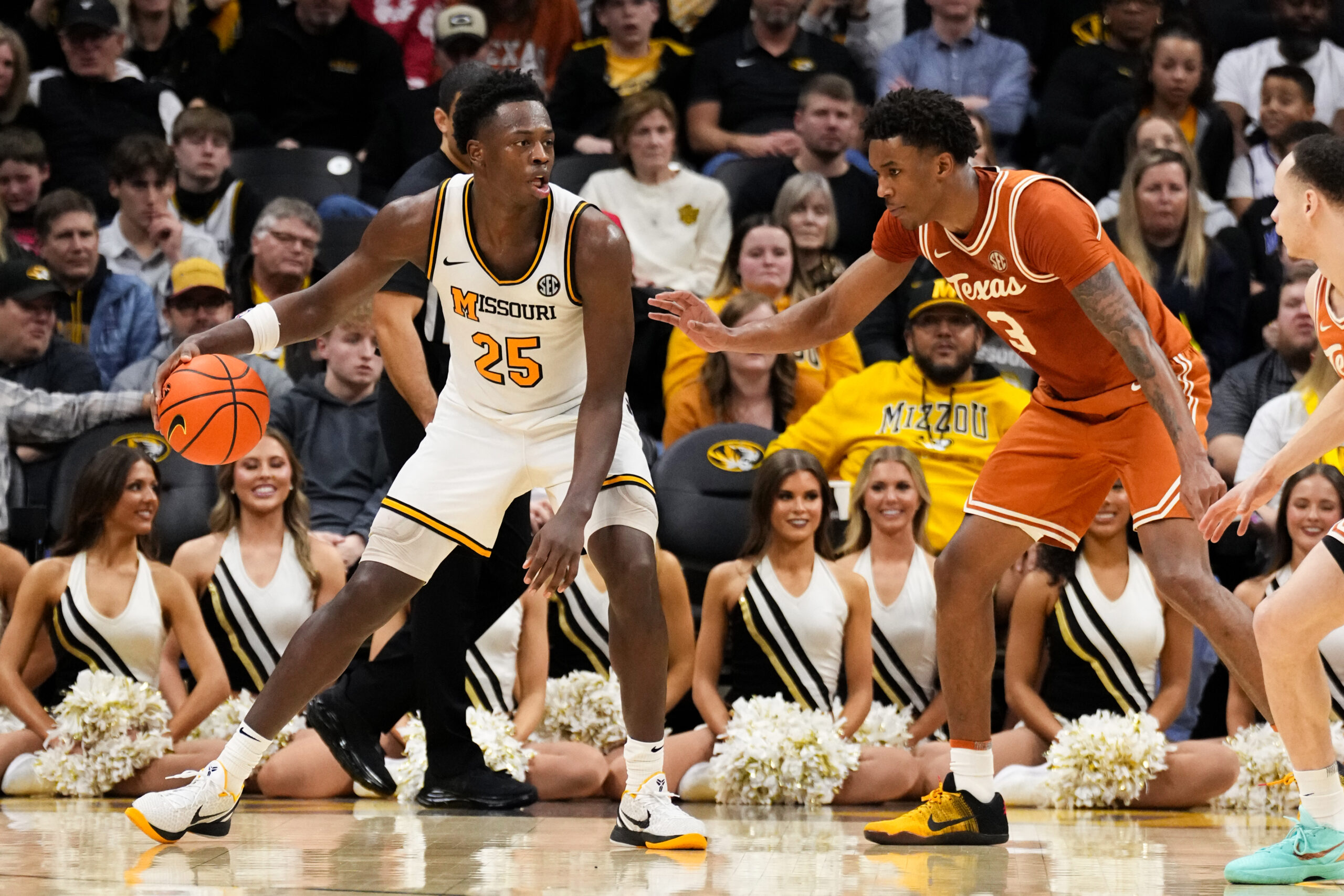 Feb 14, 2026; Columbia, Missouri, USA; Missouri Tigers forward Mark Mitchell (25) controls the ball as Texas Longhorns forward Dailyn Swain (3) defends during the second half of the game at Mizzou Arena. Mandatory Credit: Denny Medley-Imagn Images